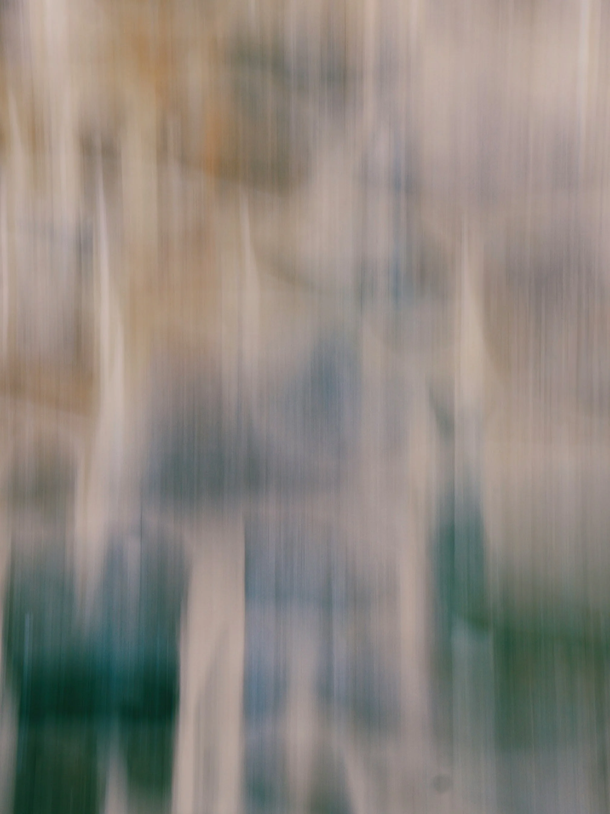 Blurred image of people walking indoors.