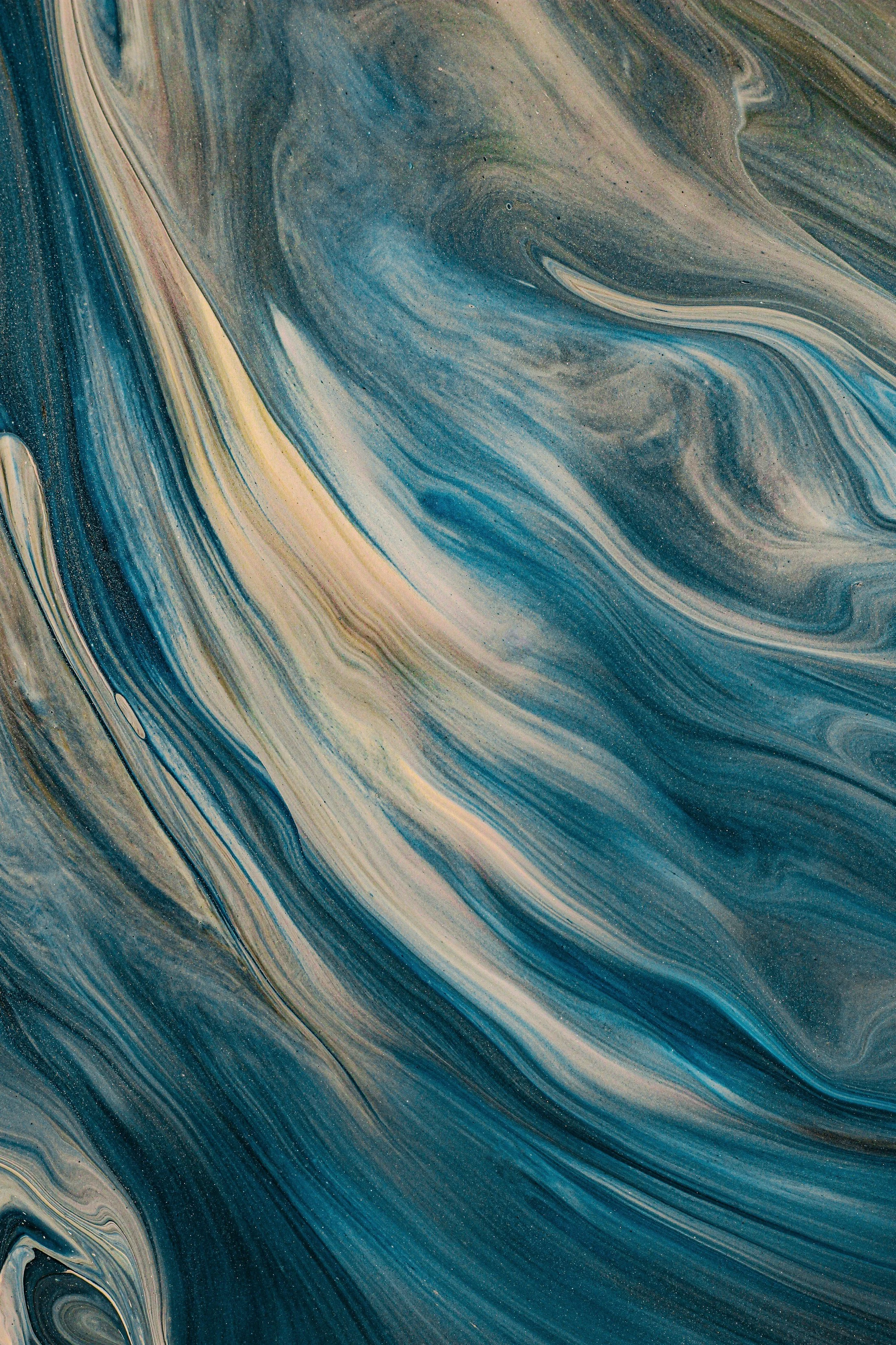 Abstract swirling pattern in shades of blue, beige, and gray