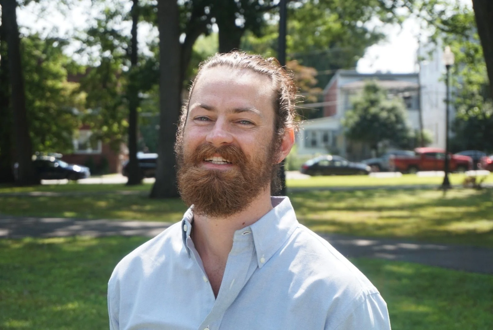 Kyle Porro laughing in a Montclair park