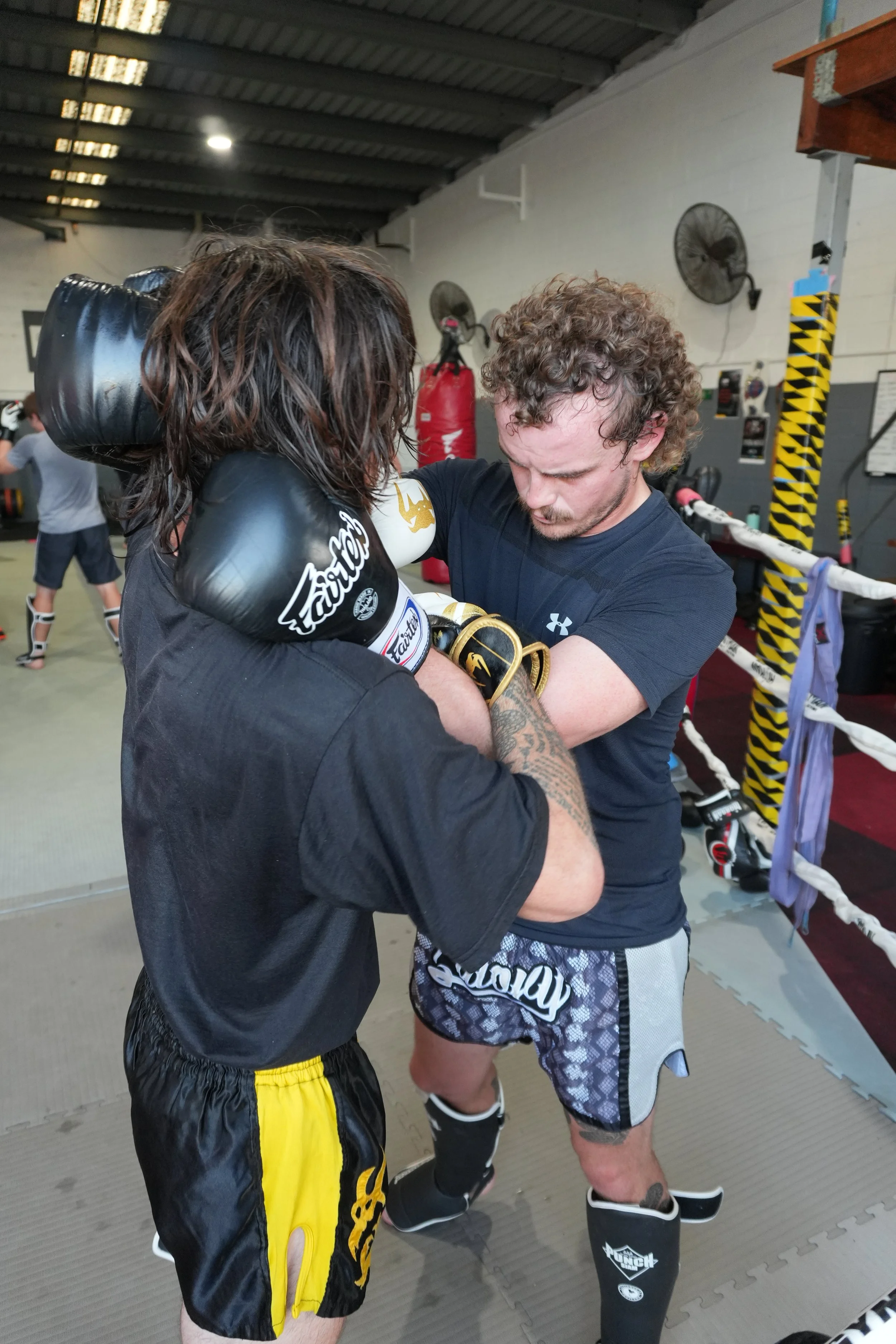 Two members practising the Muay Thai clinch at DM Muay Thai & Fitness, Tweed Heads