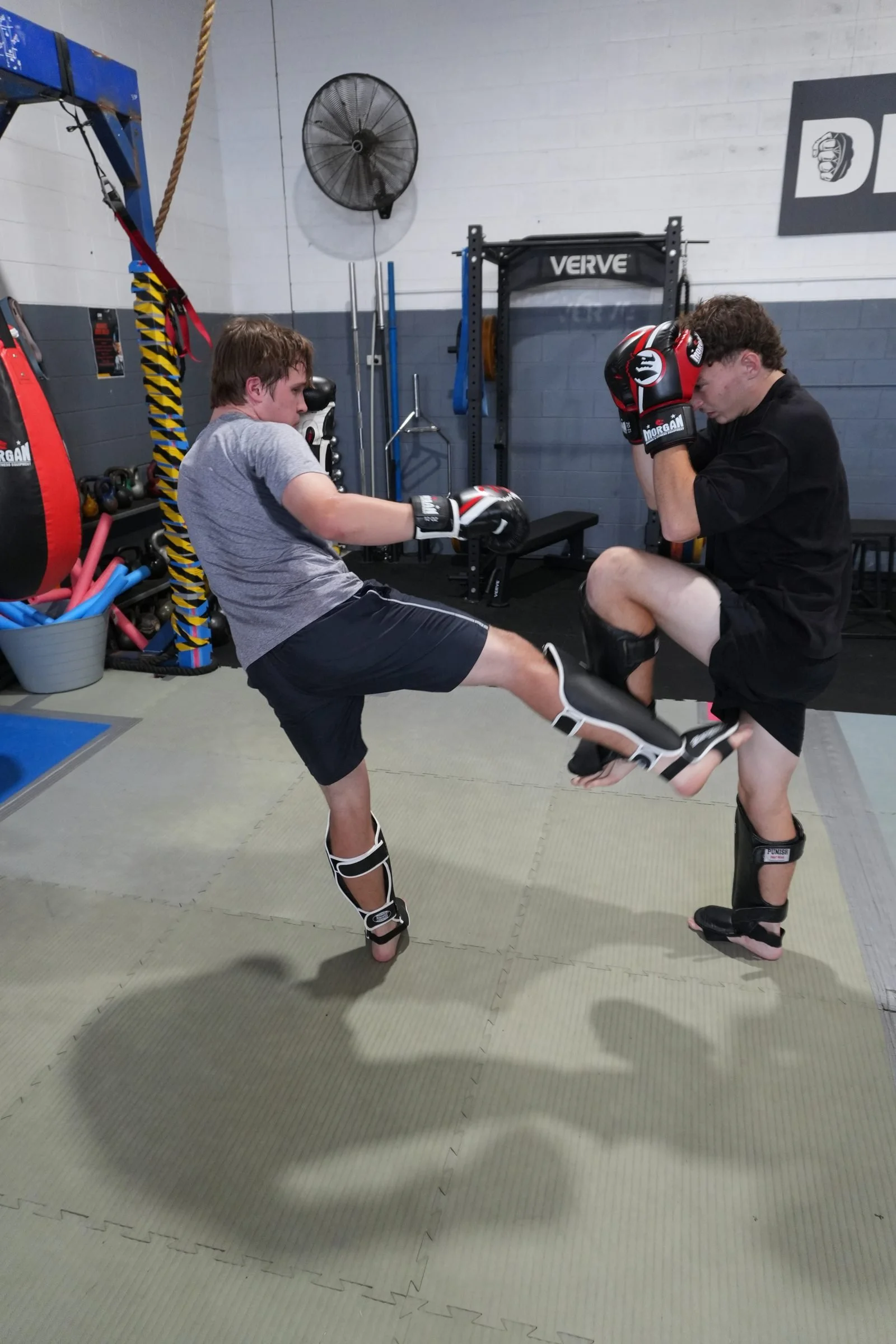 Beginner Muay Thai student training on pads with a partner at DM Muay Thai & Fitness, Tweed Heads