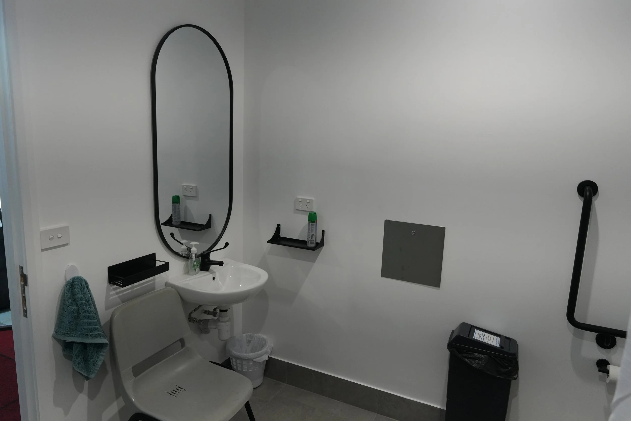Accessible bathroom with grab rail and basin at DM Muay Thai & Fitness, Tweed Heads South