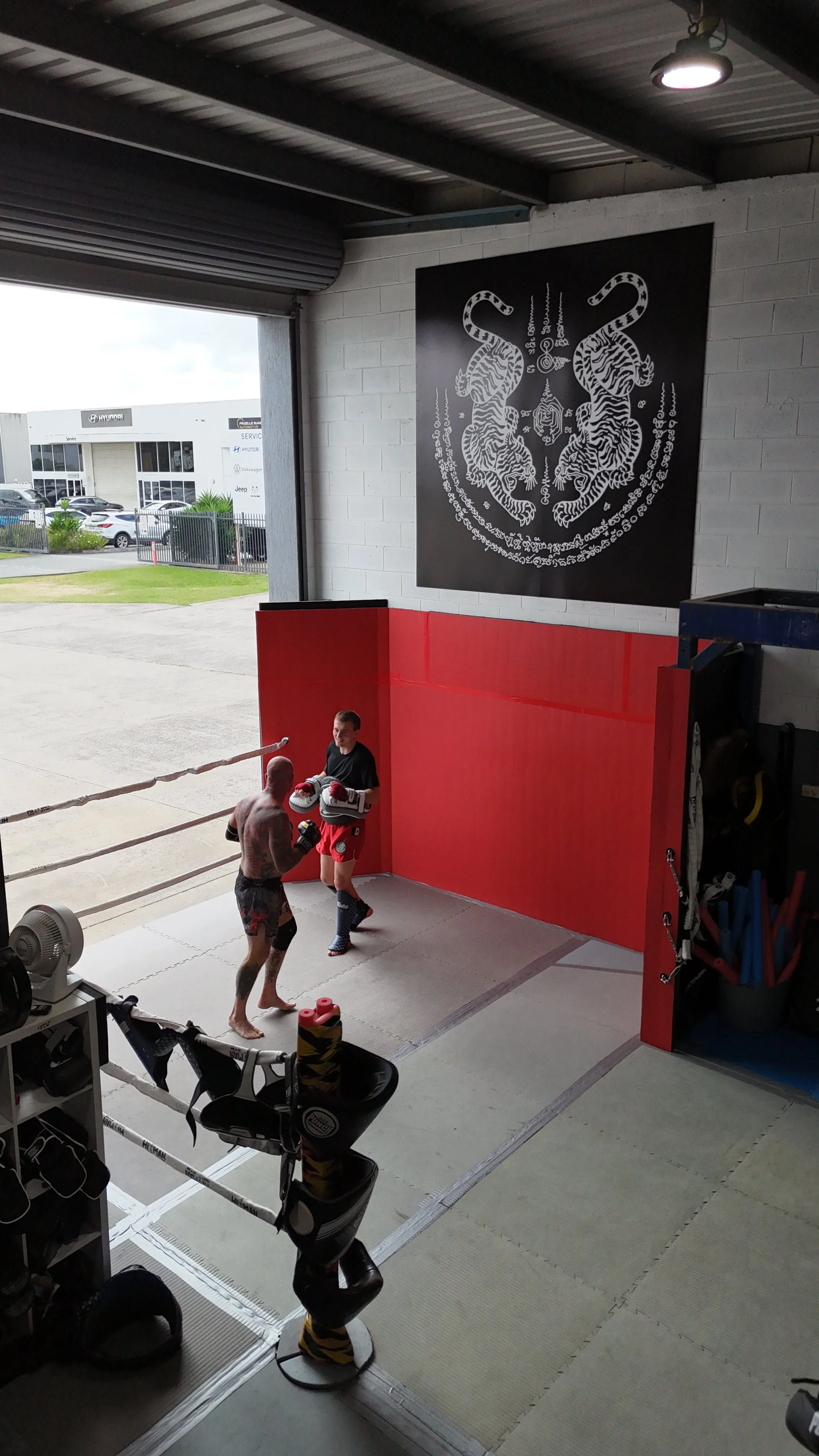 Pad work inside the boxing ring at DM Muay Thai & Fitness, Tweed Heads South