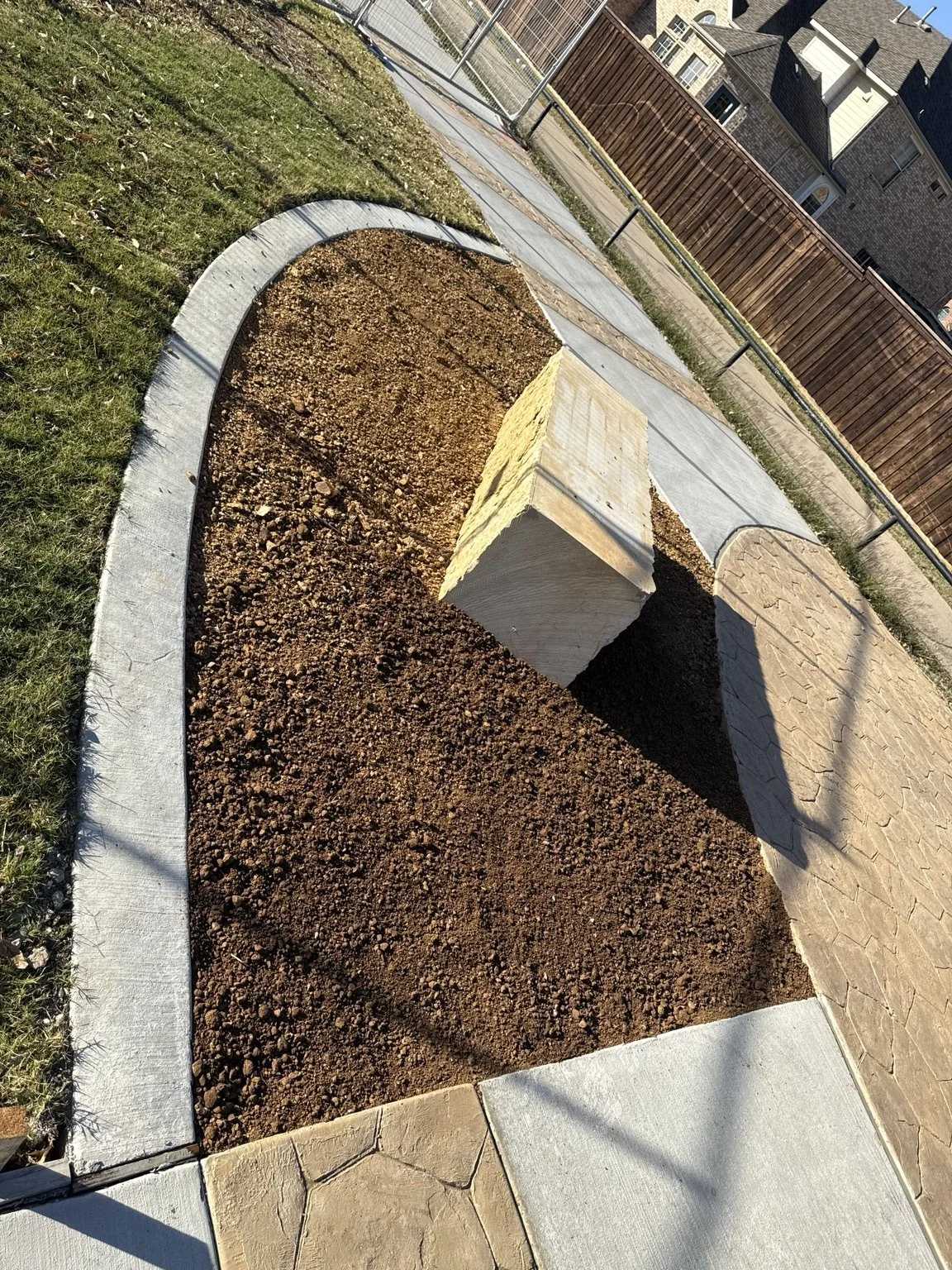Trail-side site preparation — a second view of the bench planting area.