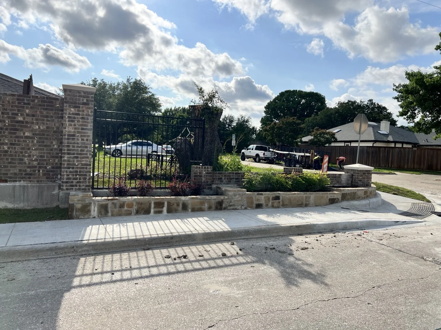 Screening-wall landscape restoration — planting beds along the completed frontage.