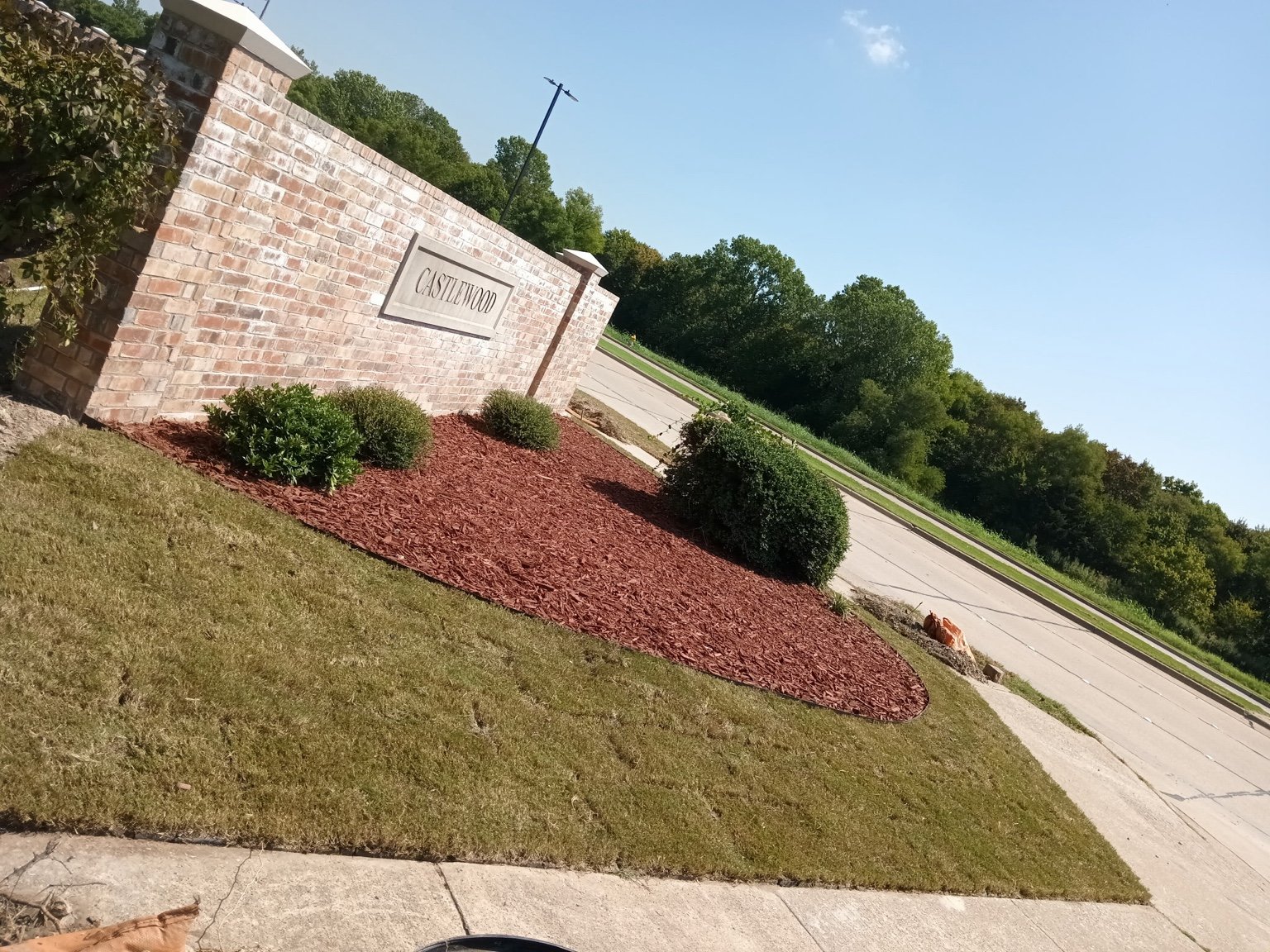 Landscape planting — mulched beds at the Castlewood neighborhood entrance.