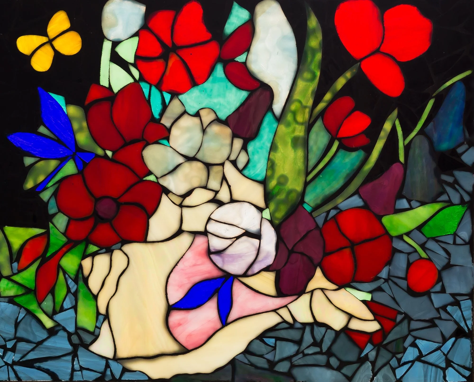 A colorful glass mosaic with red and white flowers, green stems, and a pale vase.