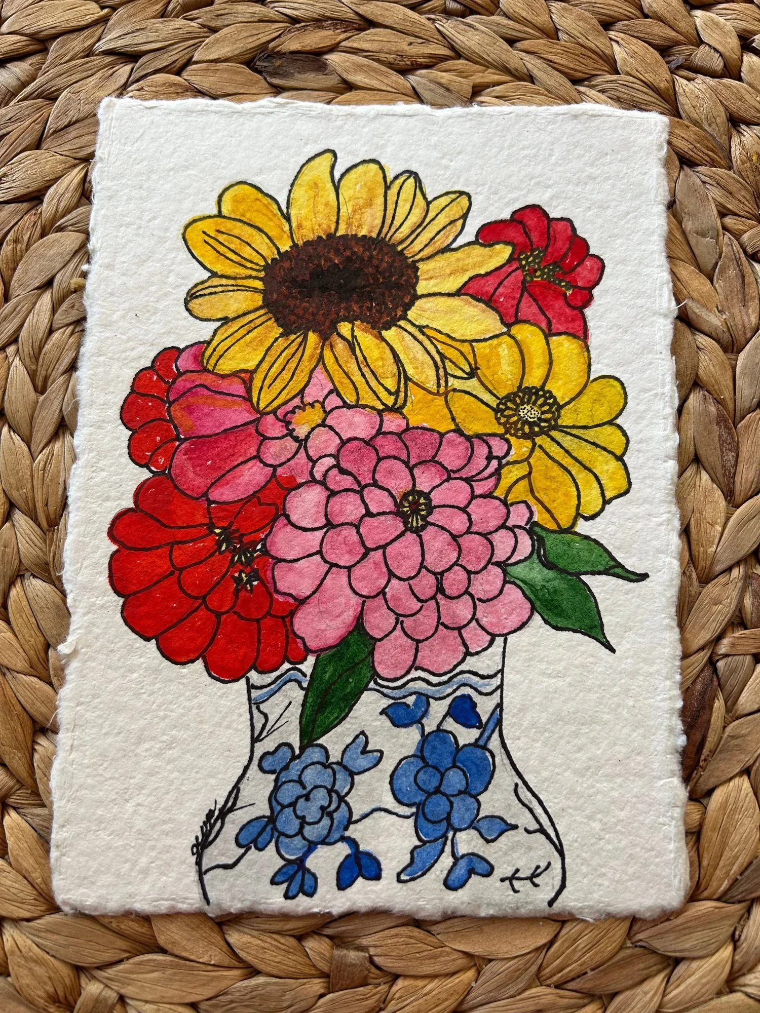 An ink and watercolor bouquet of yellow, red, pink, and blue flowers on textured paper.