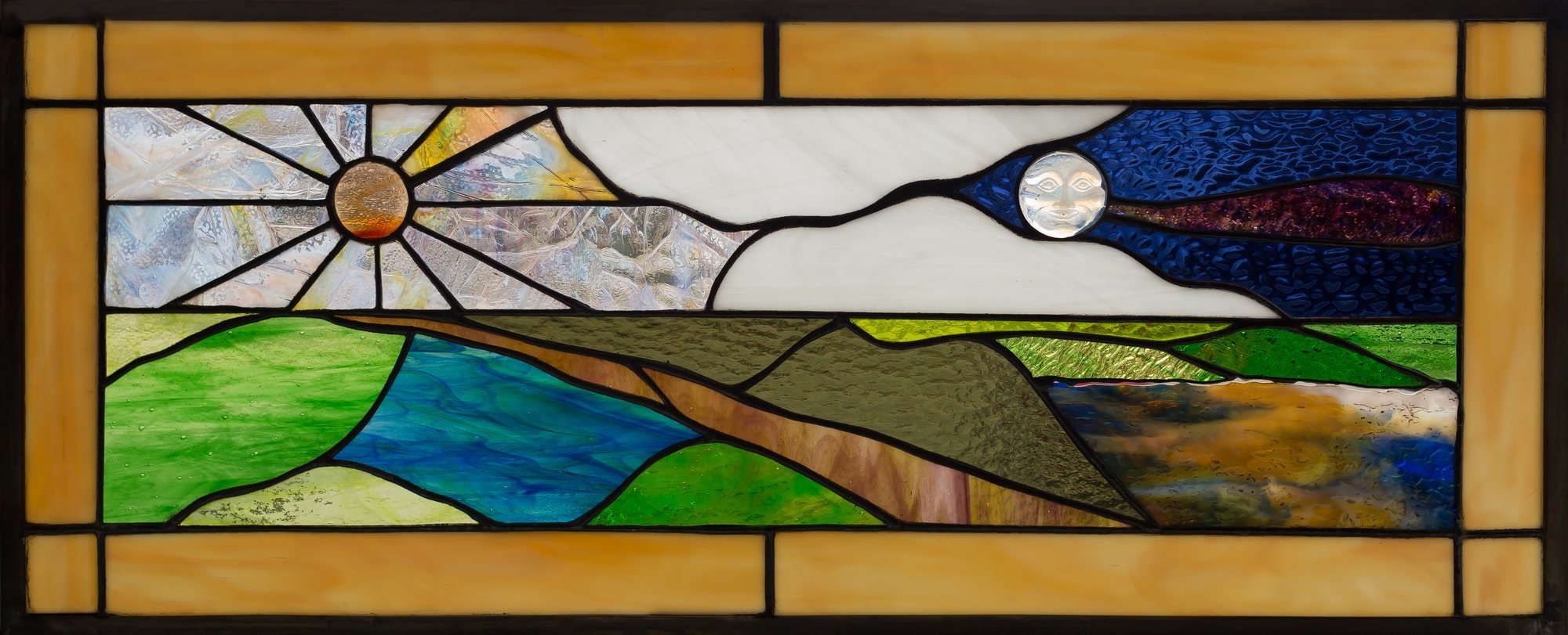 A wide stained-glass landscape with rolling green hills, a sun, and a pale moon.