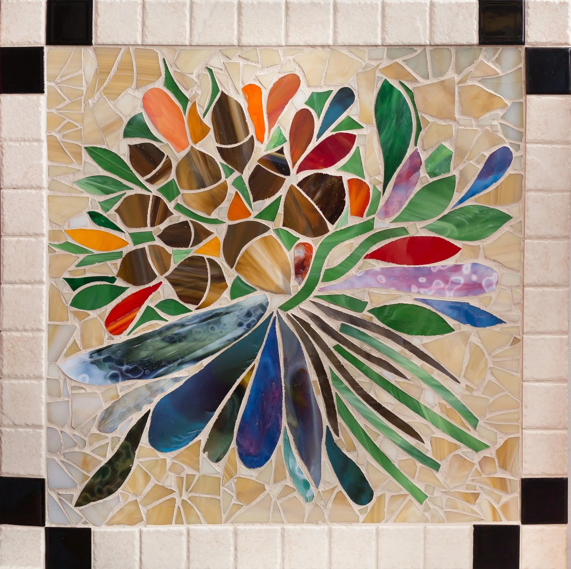 A mosaic of multicolored curved glass pieces radiating across a pale tiled background.