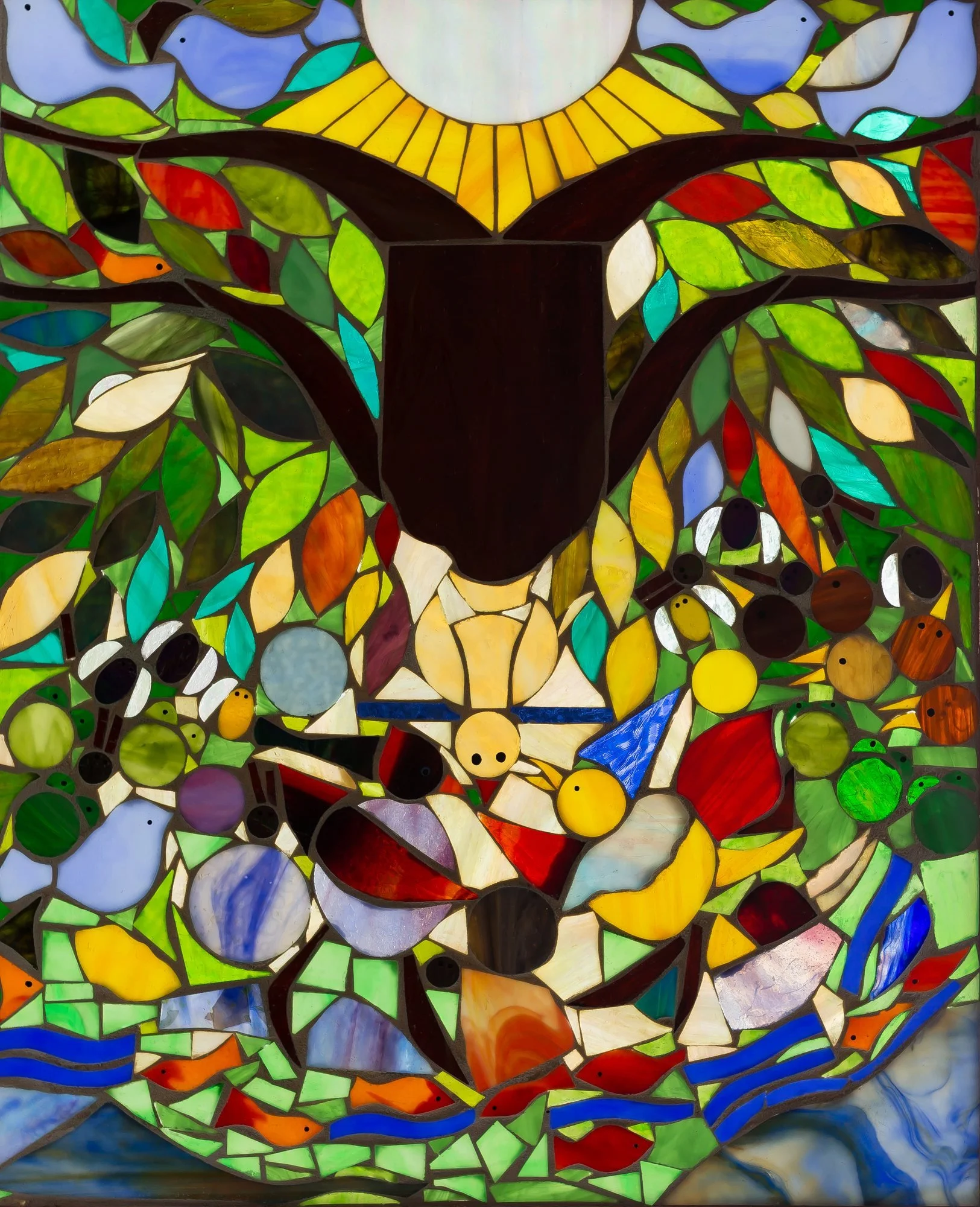 The Circus, a stained-glass window with a lively arrangement of colorful birds, foliage, and abstract forms.