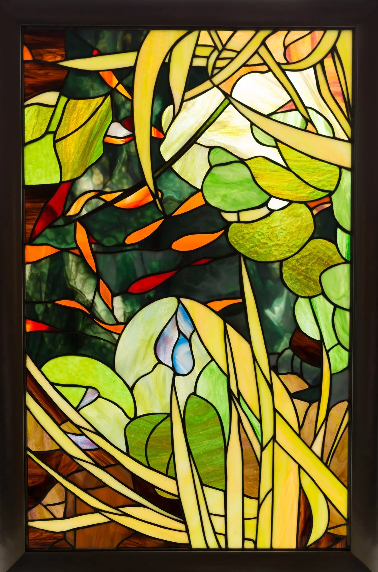 The Koi Pond, a framed stained-glass window with orange koi, green lily pads, and pale iris flowers.