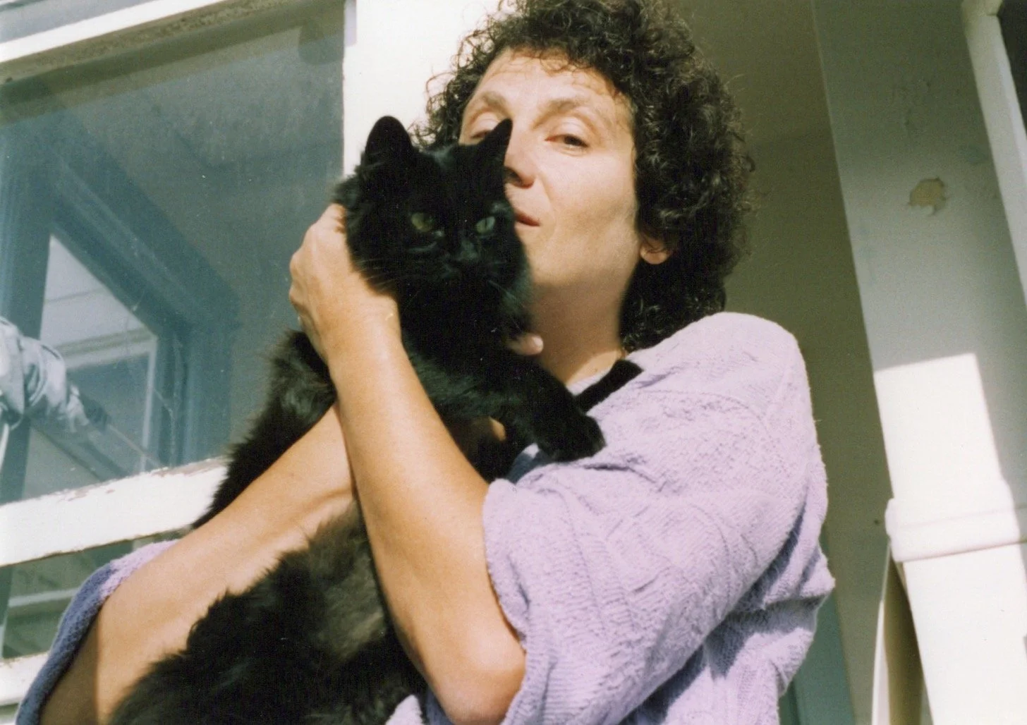 Diana with her beloved cat Shena in 1993 on the porch of their Berkeley home.