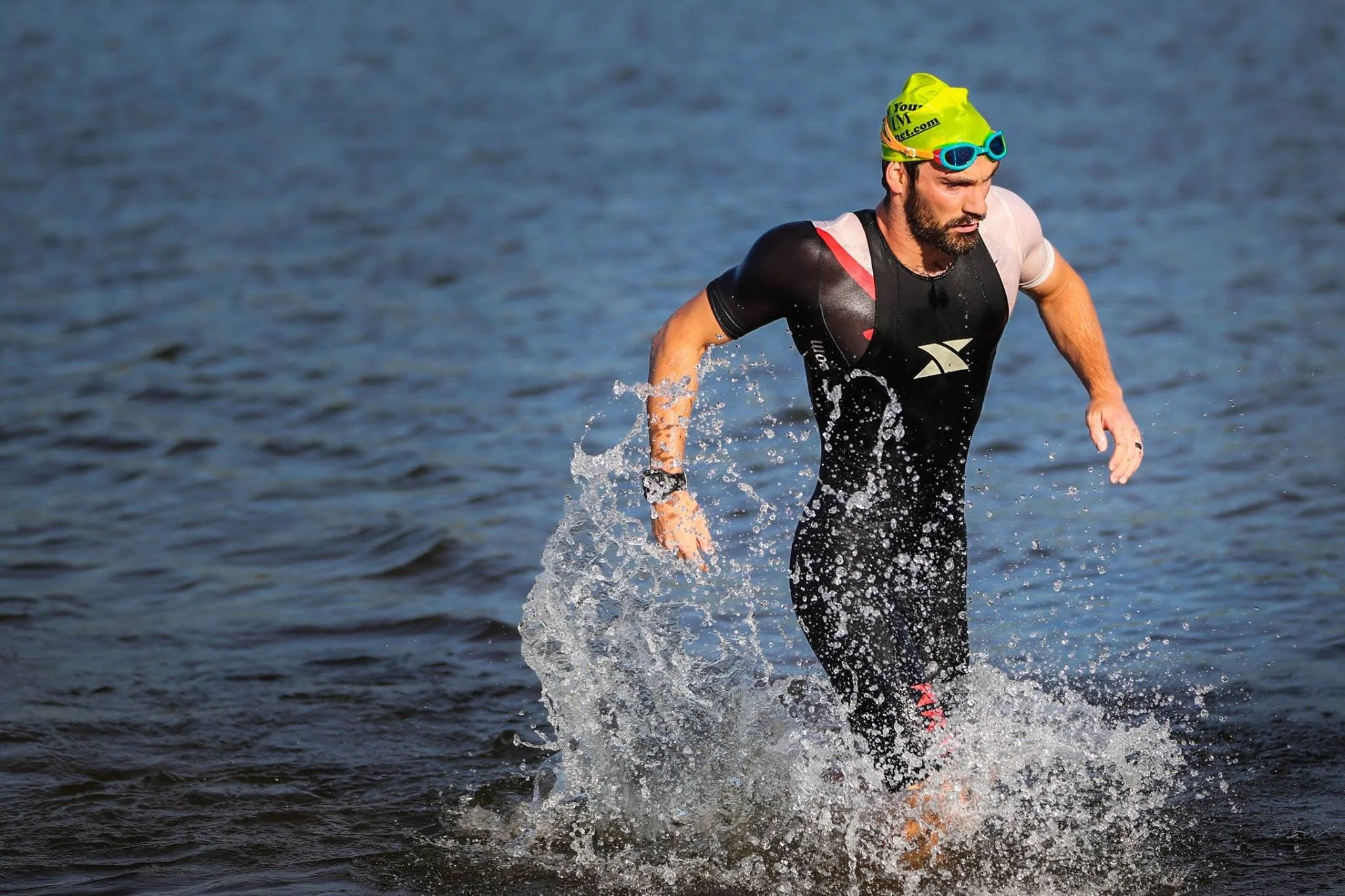 TRI2RUN coach Zach Miller exiting the swim during a triathlon