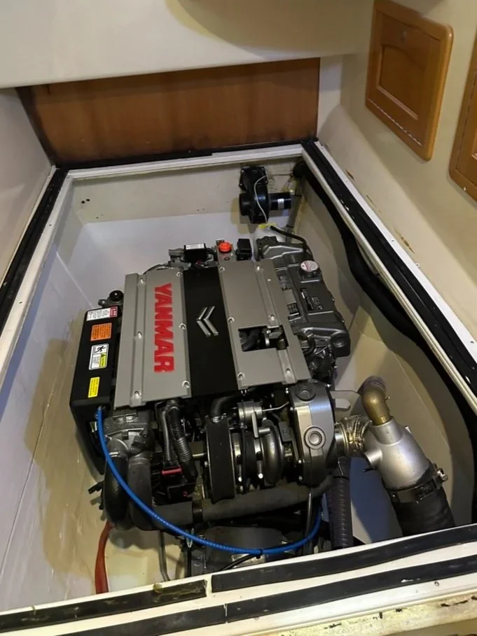 A Yamaha engine installed in a boat with a wooden cabinet nearby.