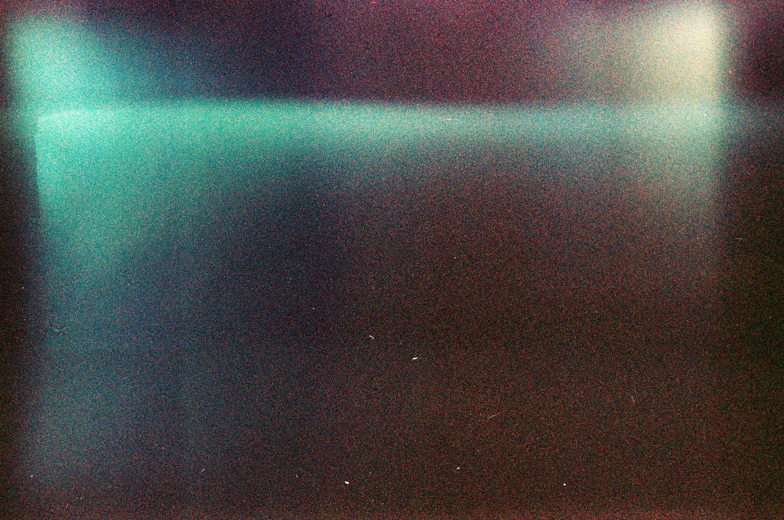 A multicolor dark gradient with film grain overlays