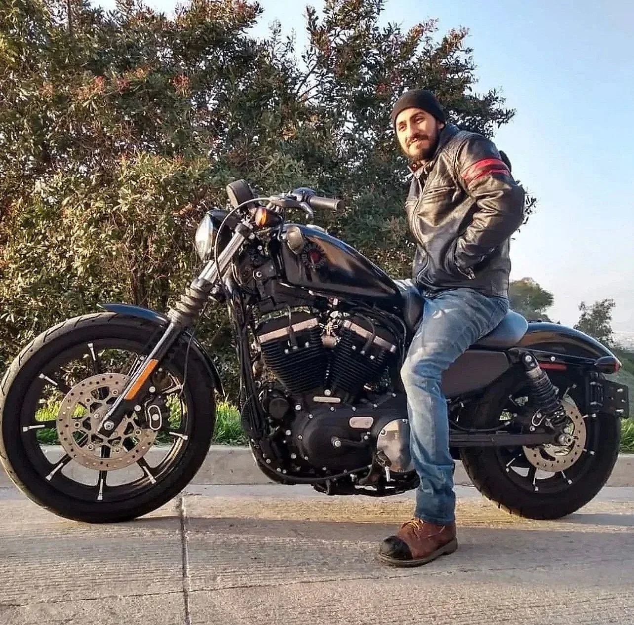 Thomas Francisco Pena sitting on his motorcycle, the man behind The Border Kid.