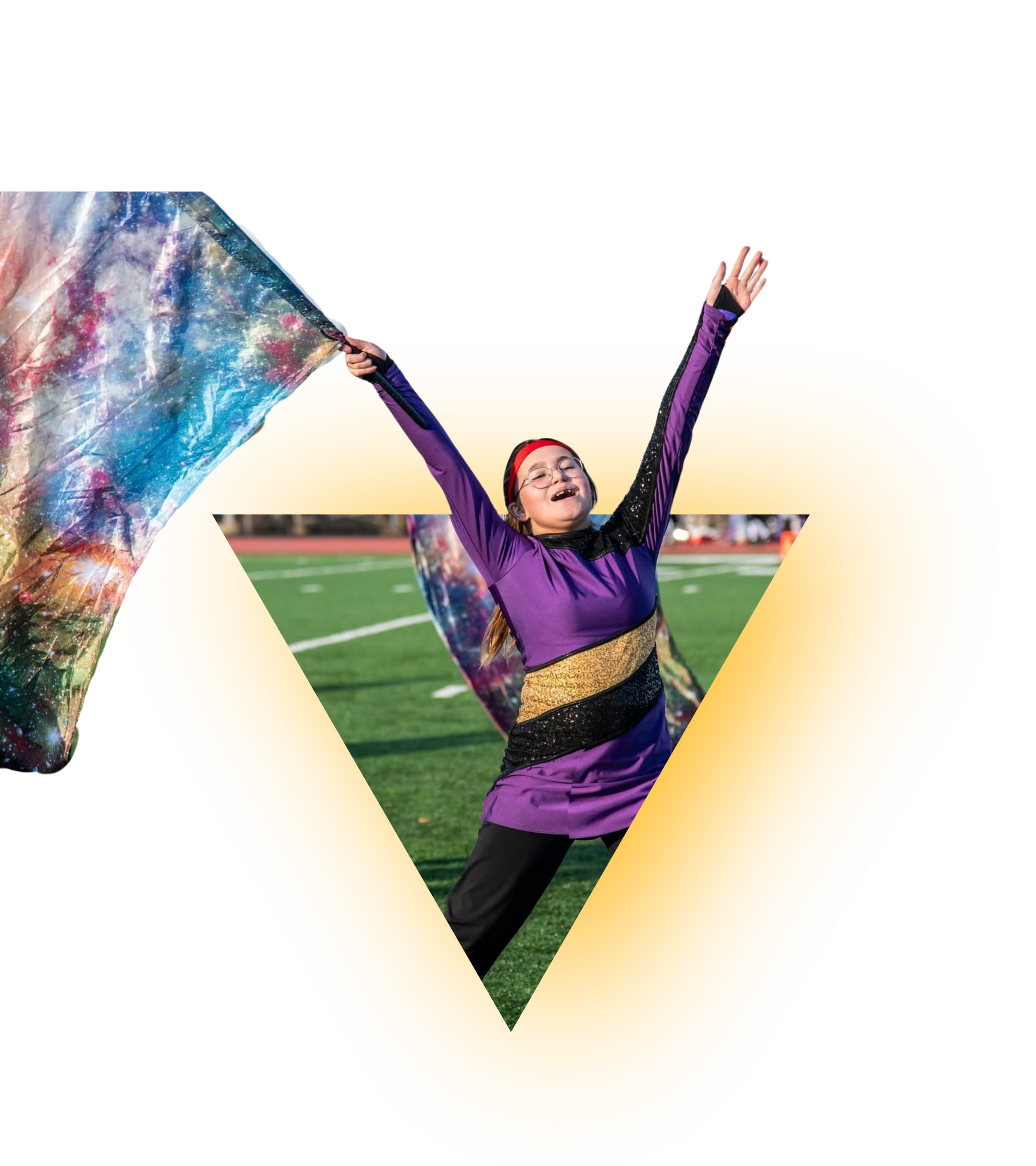 A young girl with glasses, wearing a purple jacket and a red headband, celebrating on a football field with her arms raised, holding an iridescent galaxy-patterned flag.
