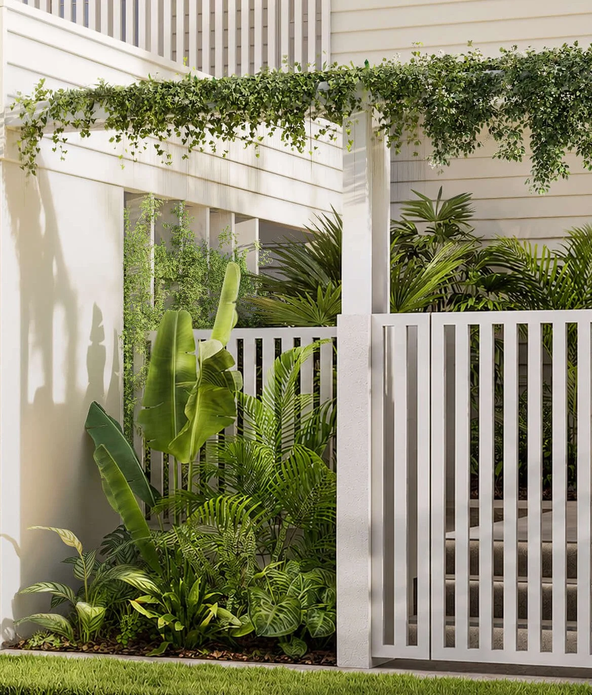 A small outdoor garden with lush green tropical plants behind a white slatted fence, with a cream wall and house siding in the background.