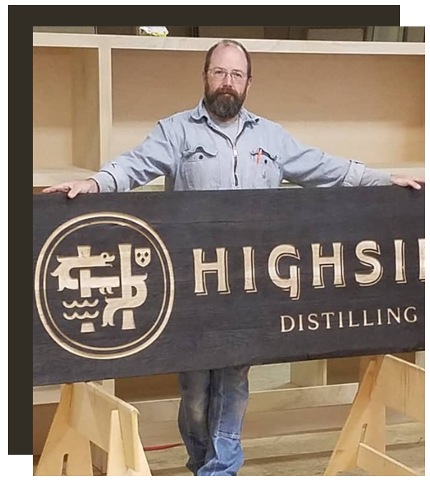 Anthony Piazza owner of bainbridge island woodworks with custom wood sign