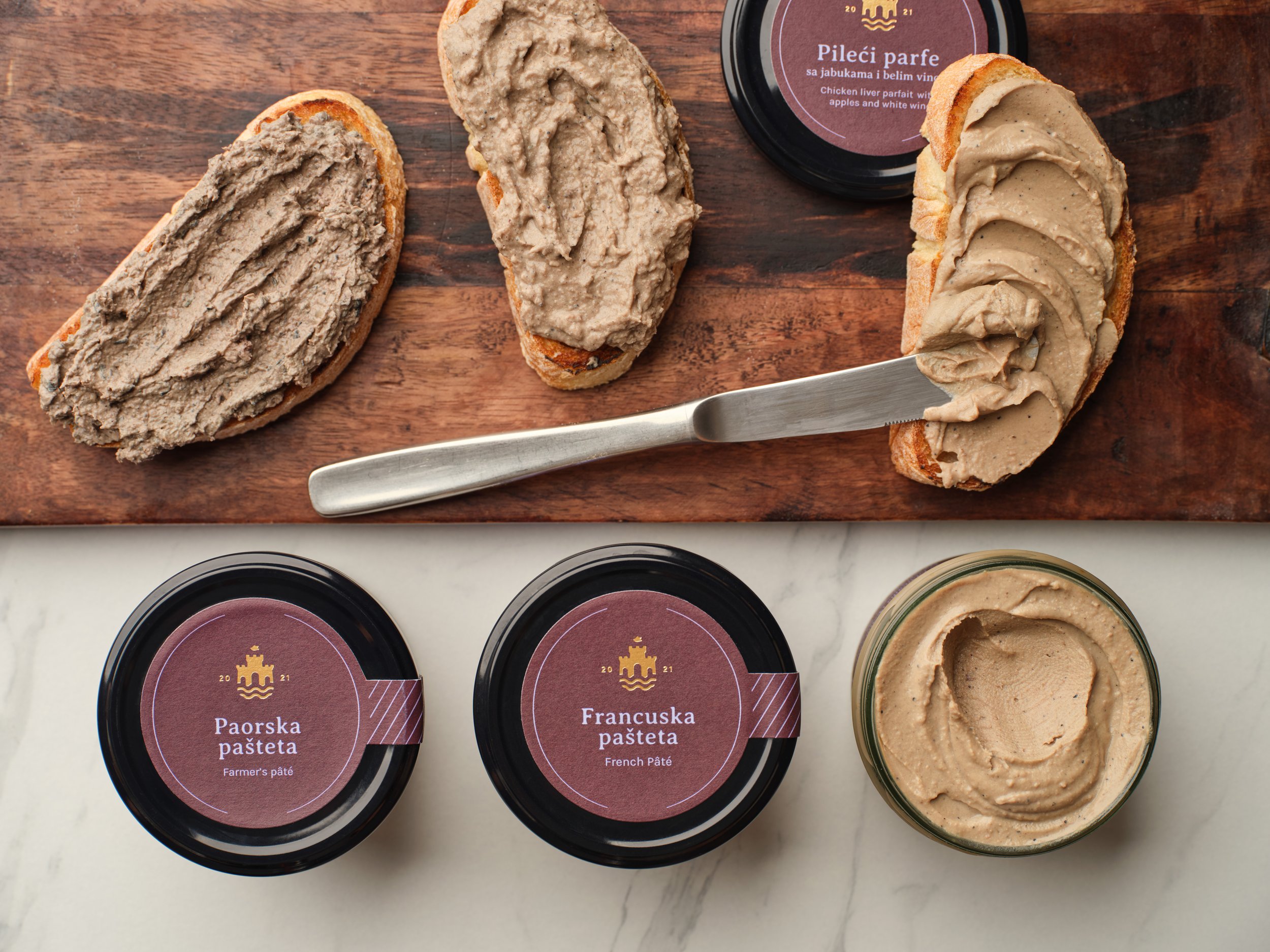 Professional product food photography featuring a selection of artisan pâtés, including farmer’s pâté, French pâté and chicken liver parfait, served on toasted bread