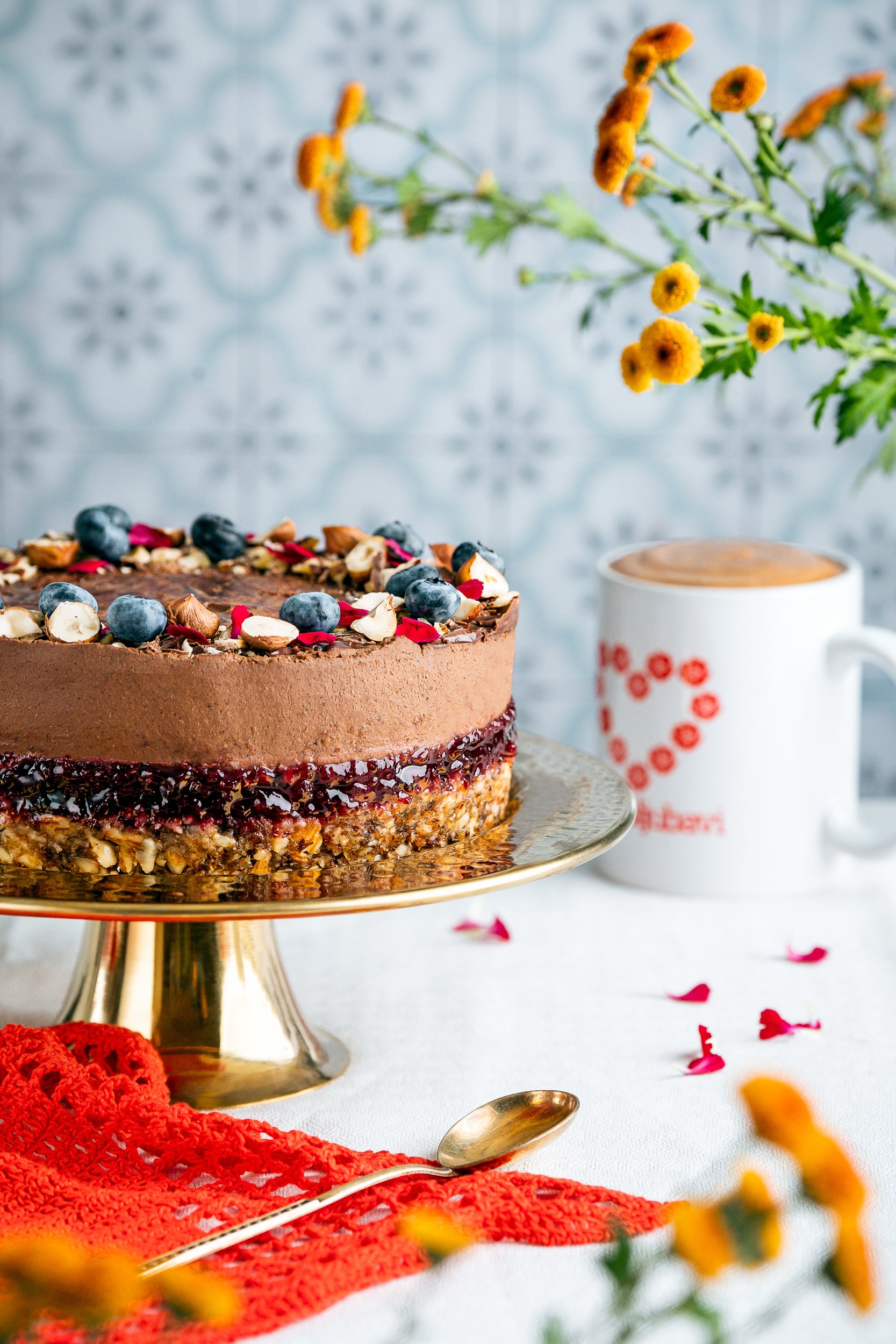 Professional dessert photography and food styling of a chocolate layer cake with blueberries, nuts and berry filling, created for bakery, food brand and advertising content