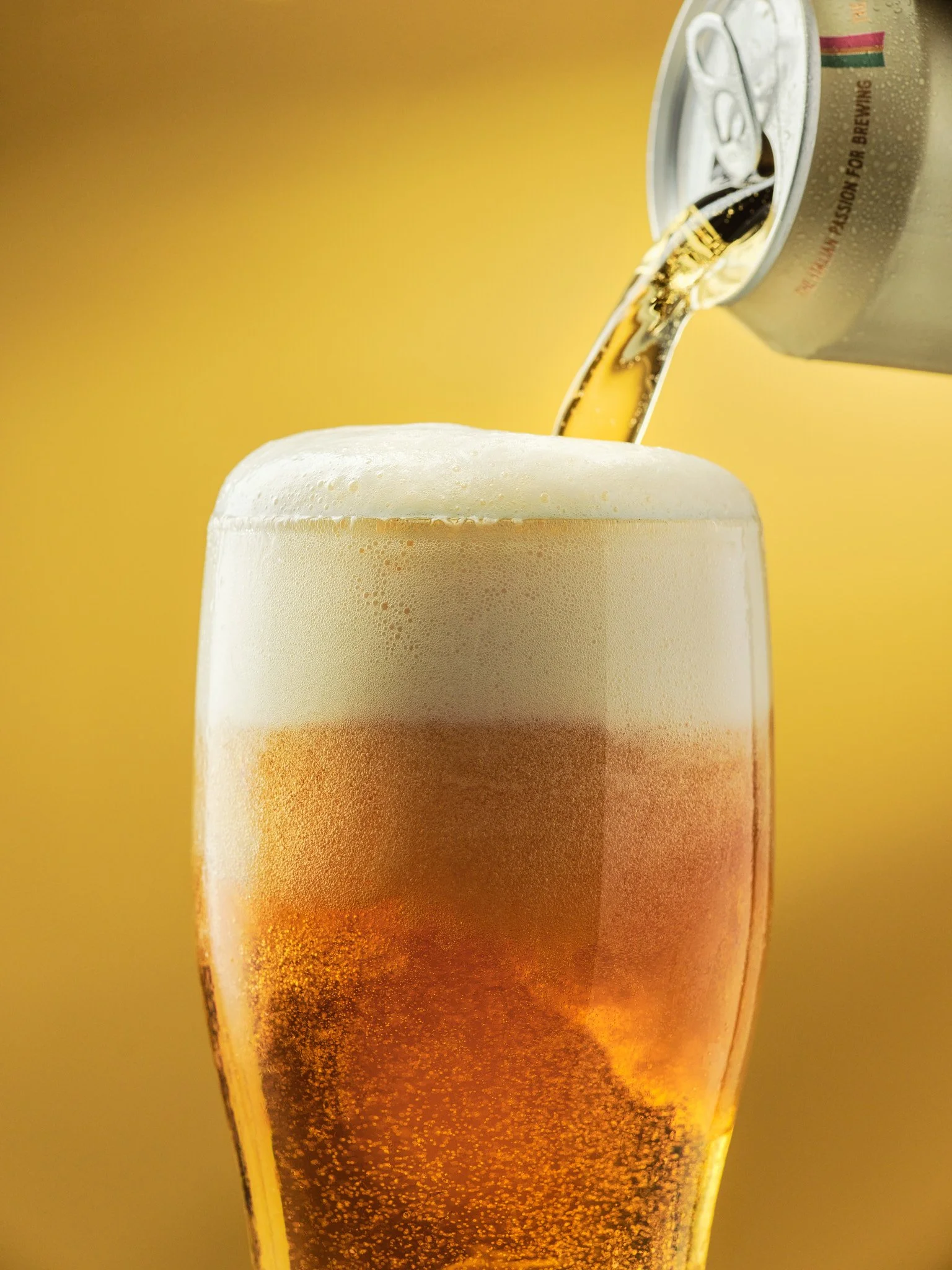 Commercial beverage photography of beer being poured into a glass, styled for advertising and product campaigns