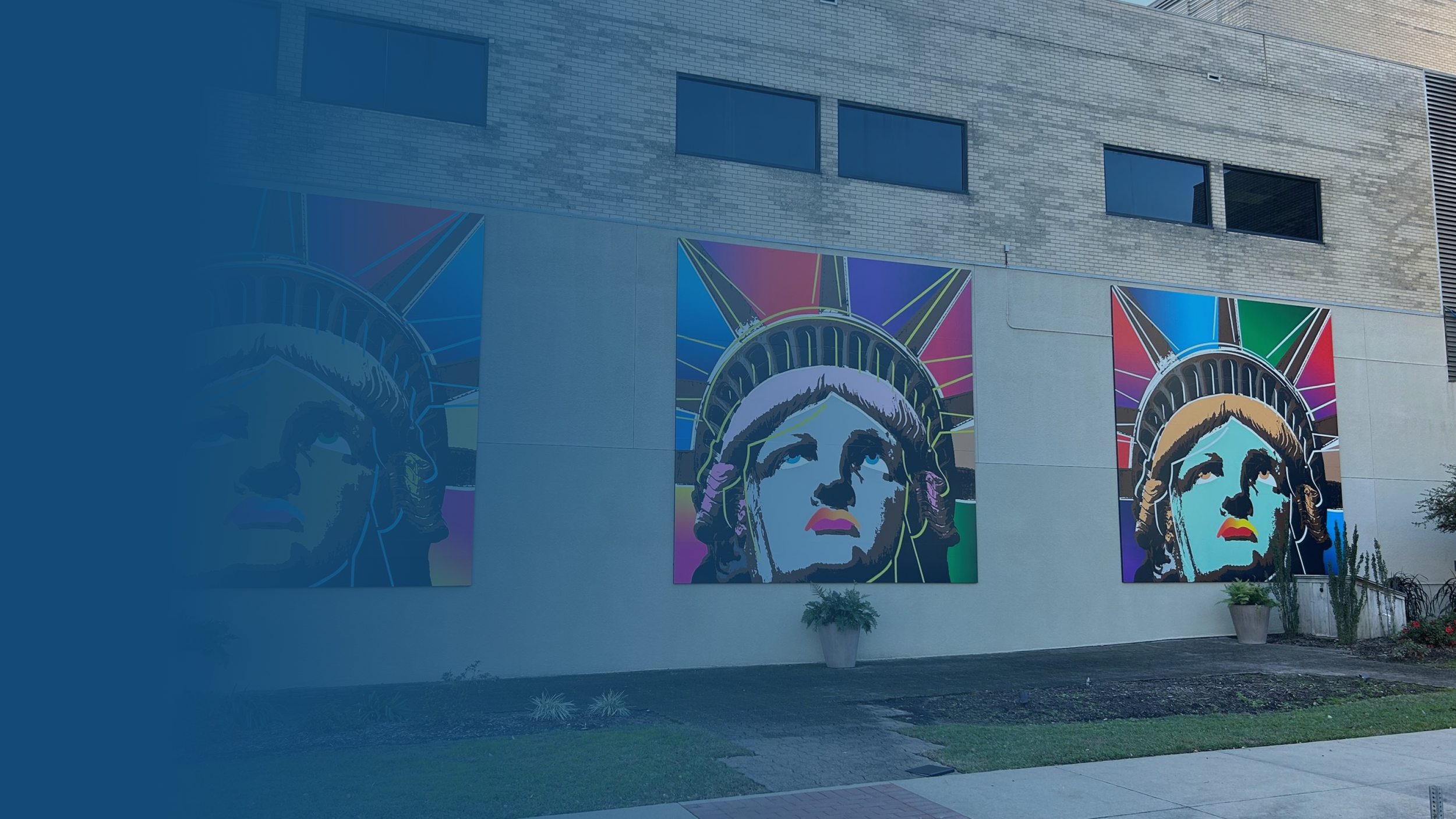 Colorful murals of a woman with a headdress on an exterior wall of a building.