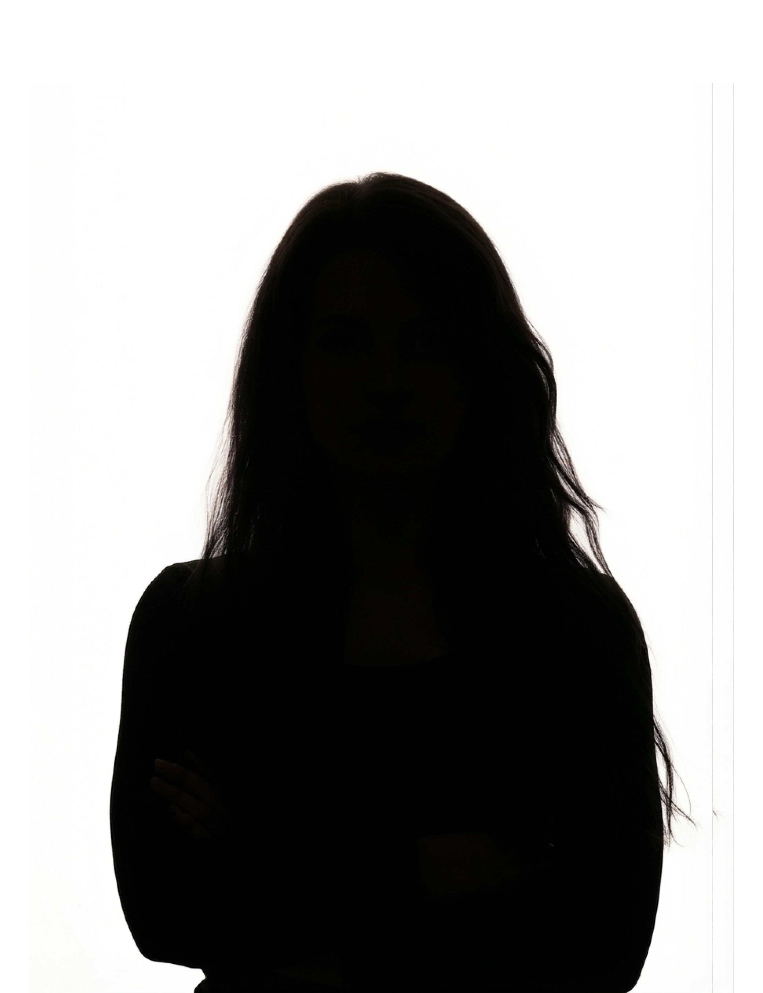 Silhouette of a woman with long hair standing against a white background.