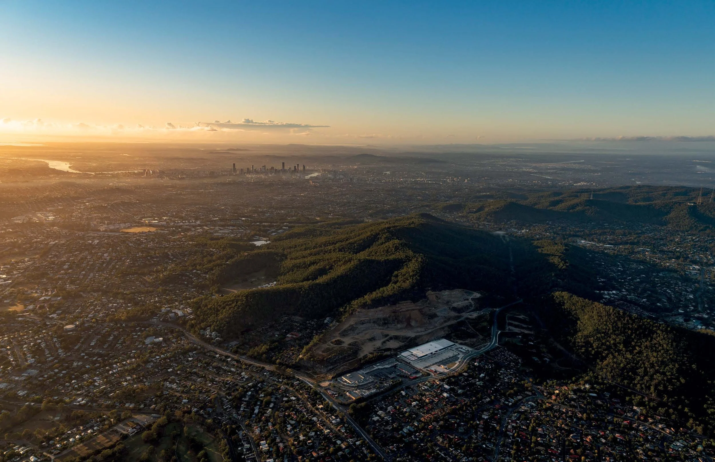 The Quarry aerial site context at dusk