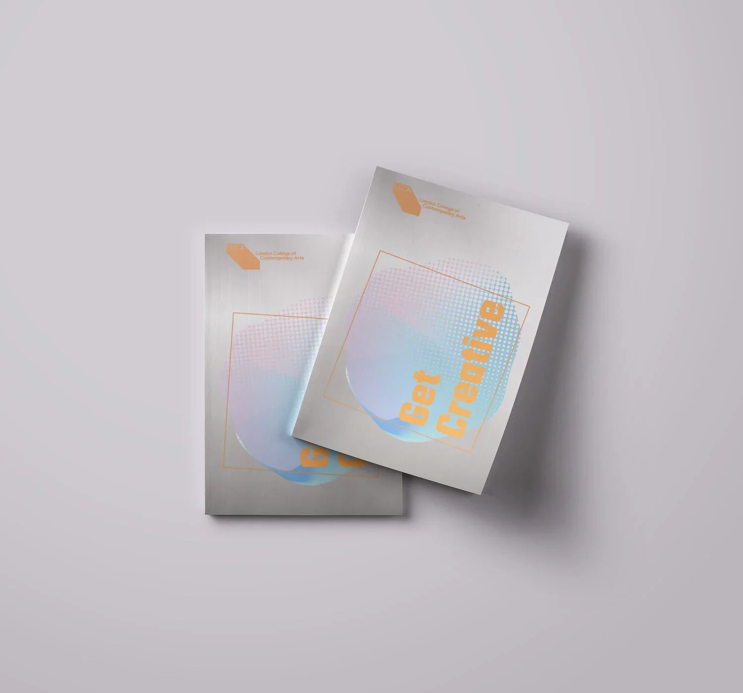 Two brochures with holographic design and the words "Get Creative" on the front, placed on a plain light gray surface.