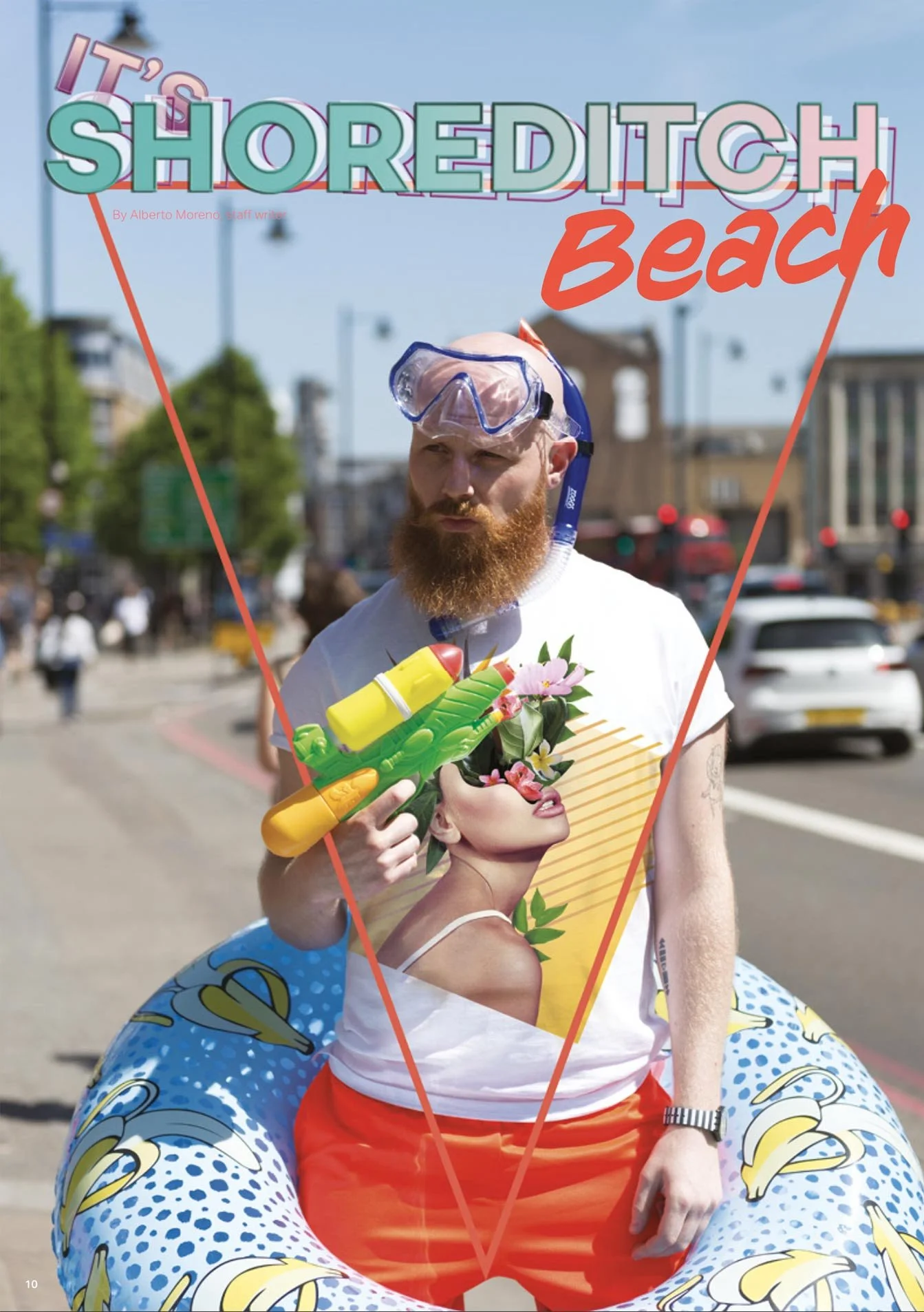 A man with a red beard wearing goggles and holding a yellow water gun, standing behind or in front of a mannequin head with painted face and flowers, in an outdoor urban setting with cars and buildings in the background.