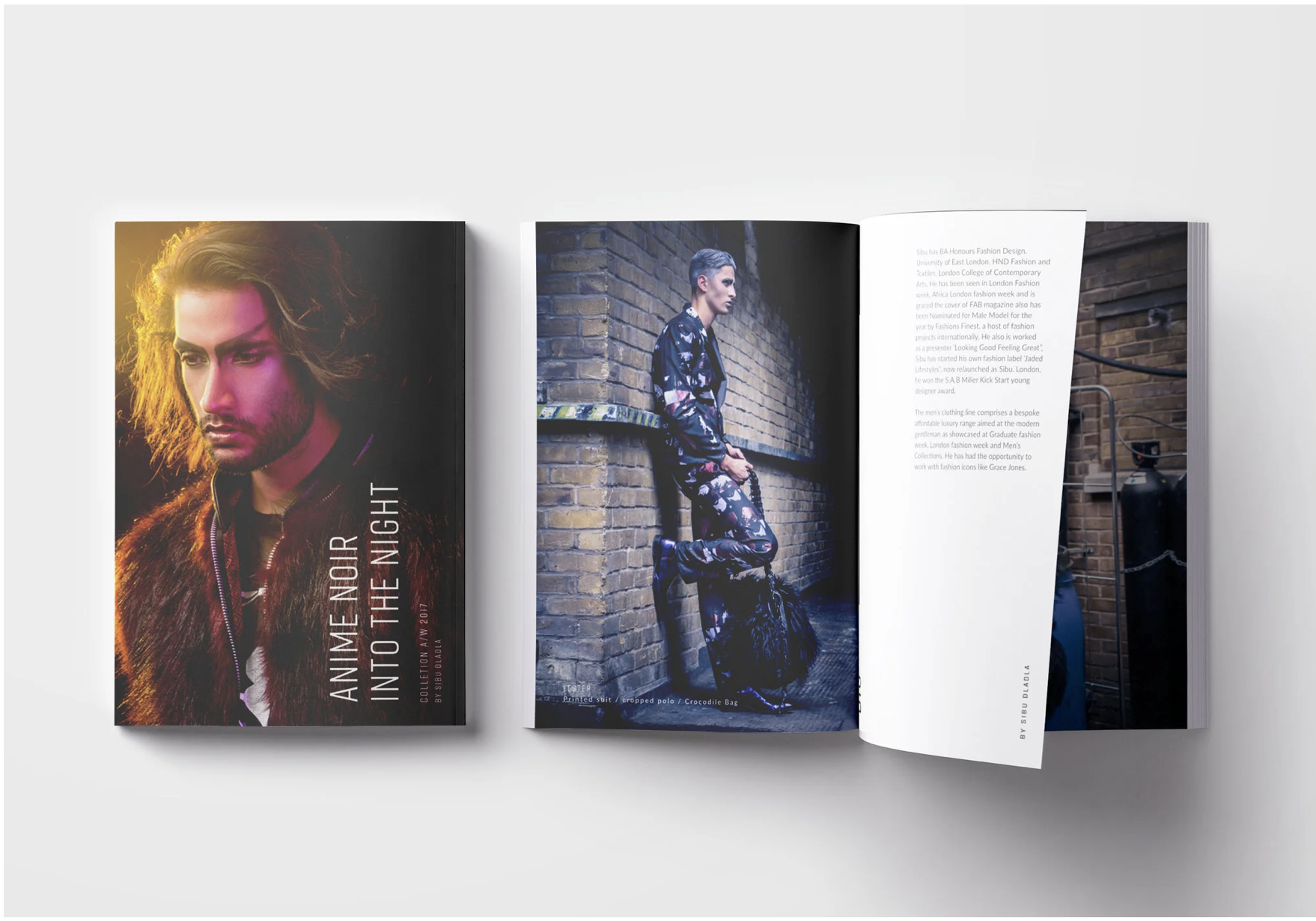 Open magazine with fashion photos, featuring a portrait of a man with long hair and a beard on the left page, and a model in a printed suit with a backpack standing against a brick wall on the right page.