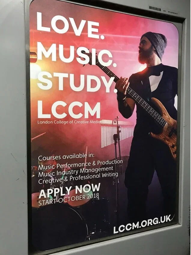 Advertisement poster for London College of Creative Media (LCCM) showing a man playing an electric bass guitar on stage with a sunset-colored background.