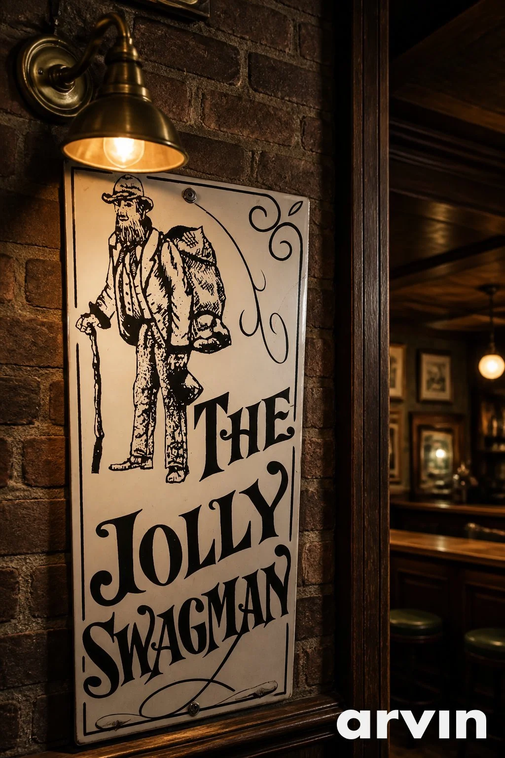 A vintage-style sign featuring an illustration of a man with a beard and hat, carrying a backpack and walking with a cane, with the text "The Jolly Swagman". The sign is mounted on a brick wall in a dimly lit interior space.