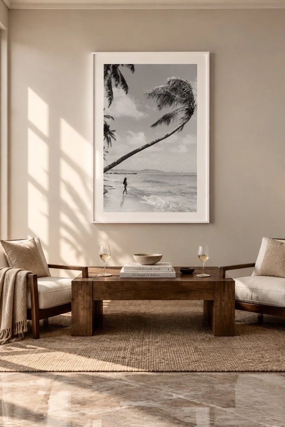 Getaway, a black and white photograph of a beach figure beneath a leaning palm, framed above a seating area. Fine art photography prints by Terron Studio.