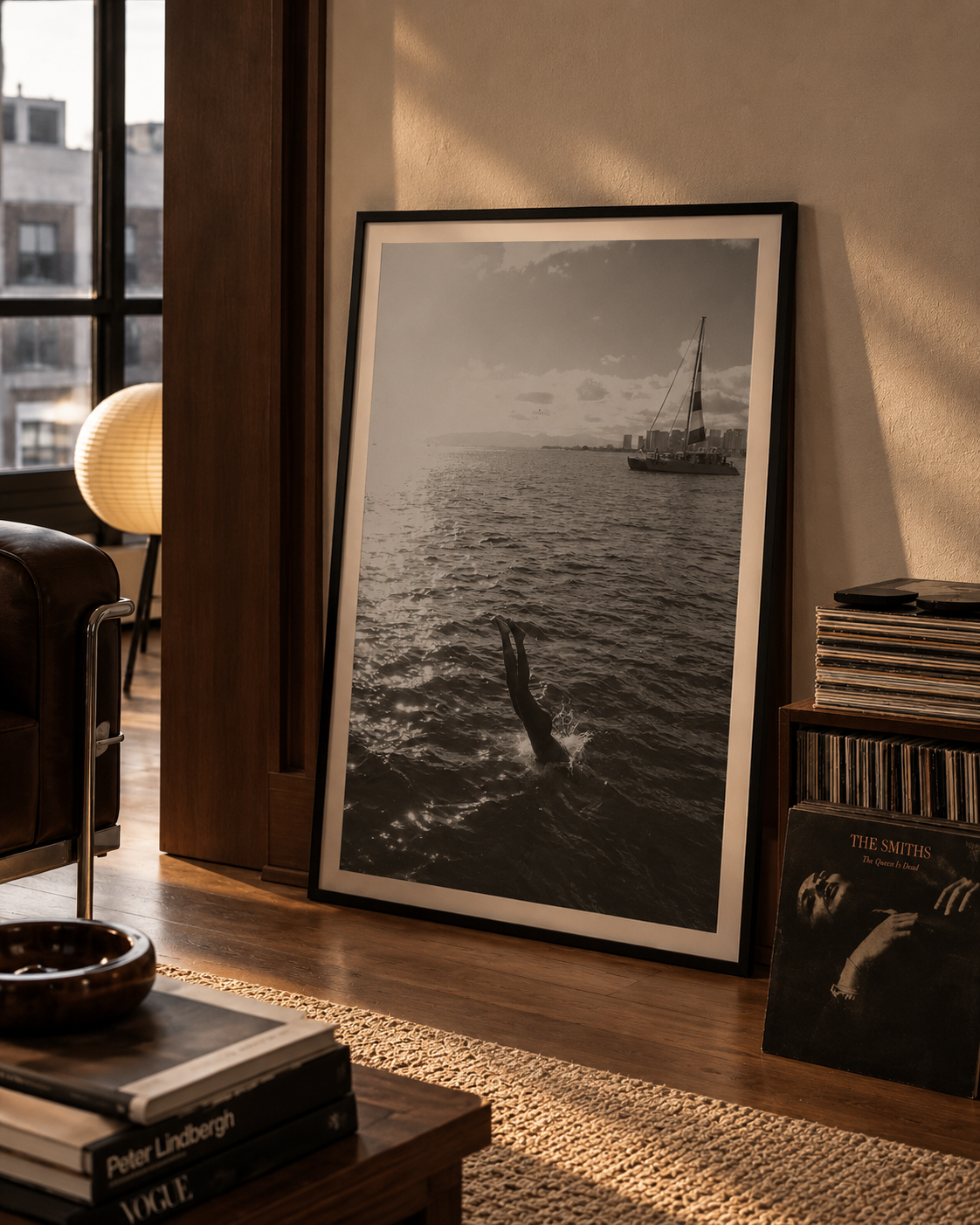 A black and white photography of a girl diving head first into the ocean from a boat. Fine art photography prints by Terron Studio.