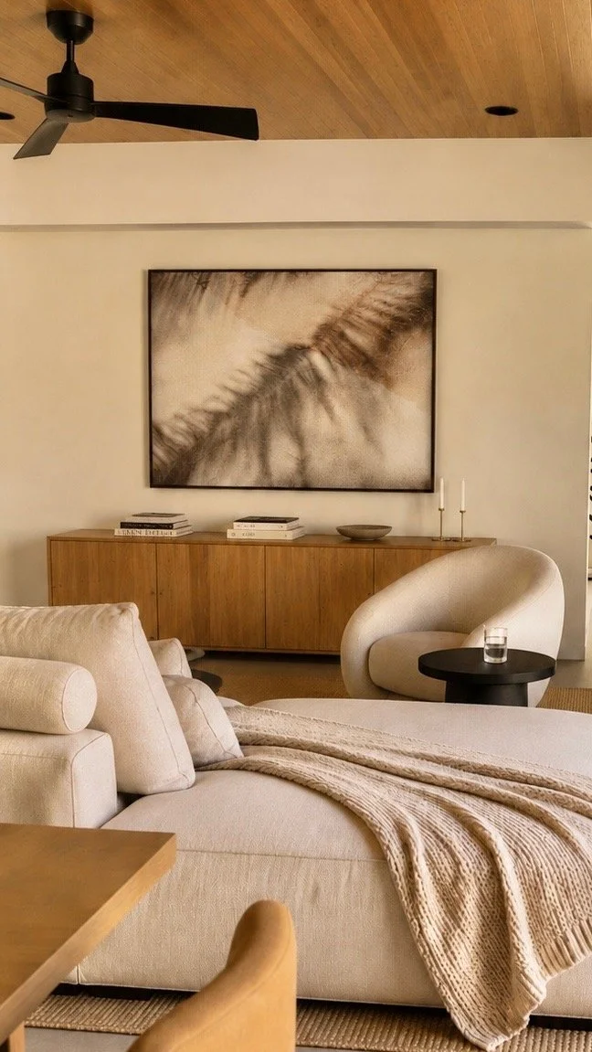Palm on Shore, a warm-toned abstract photograph of soft palm forms, displayed above a wooden sideboard. Fine art photography prints by Terron Studio.