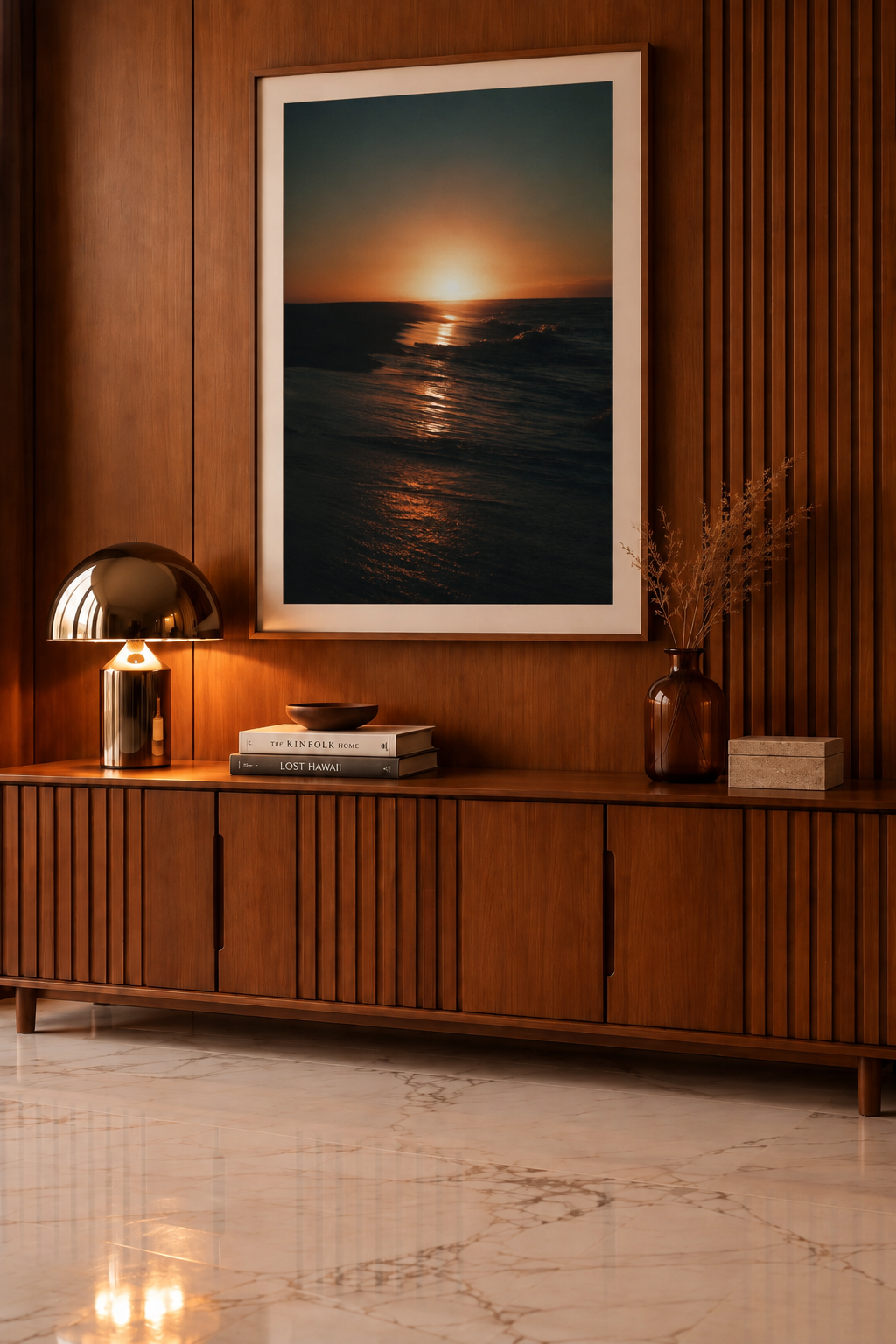 New Light, a color photograph of a golden sunset over dark ocean waves, framed above a wooden cabinet. Fine art photography prints by Terron Studio.
