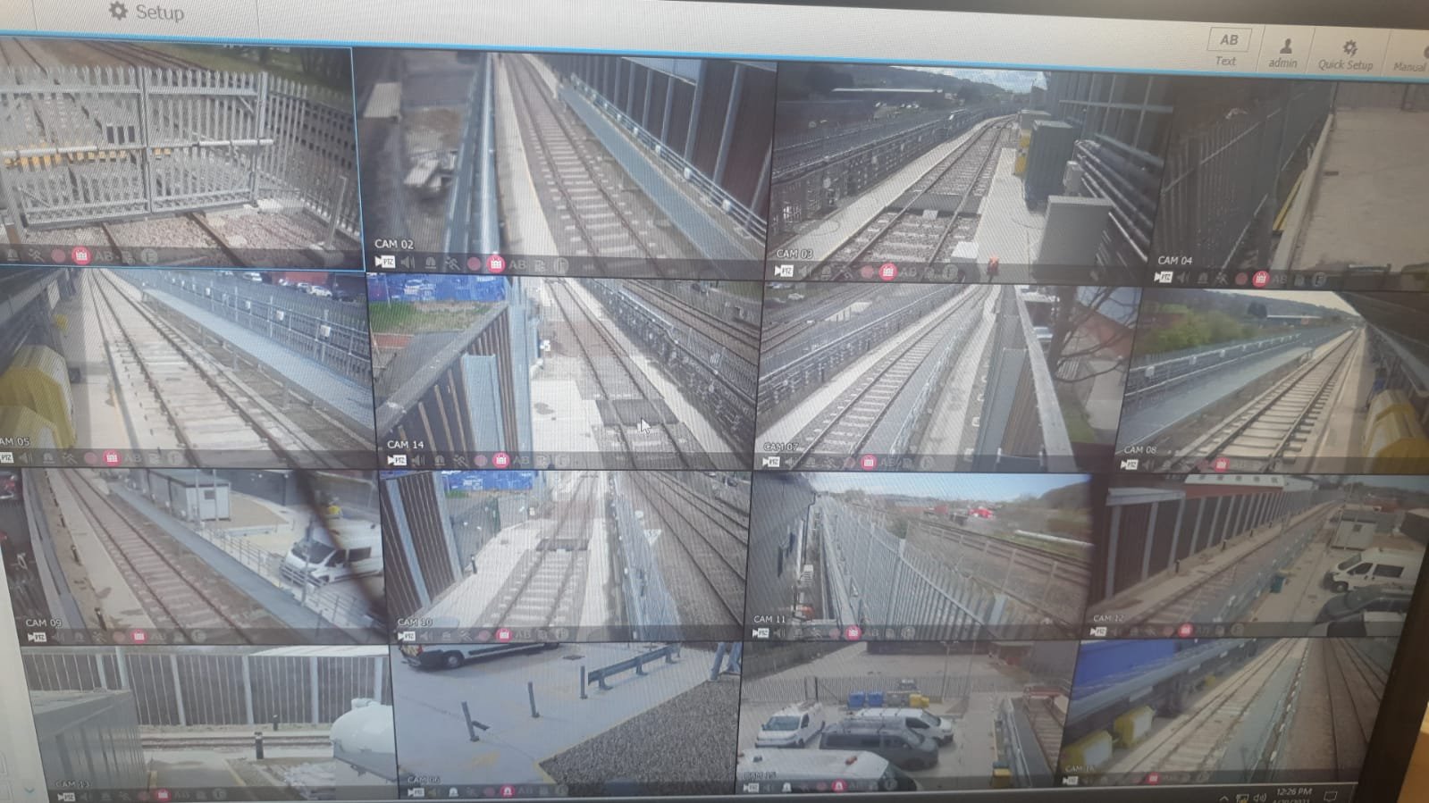 Multiple surveillance camera feeds showing a railway and station platform at different angles.