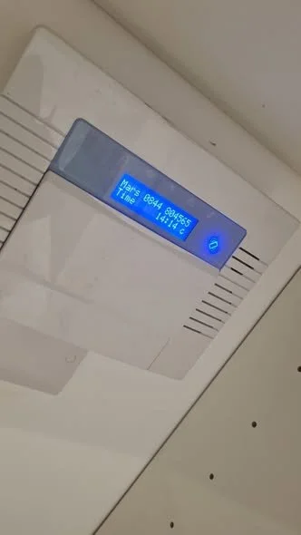 Ceiling-mounted digital display with blue backlight showing Mars rover mission details.
