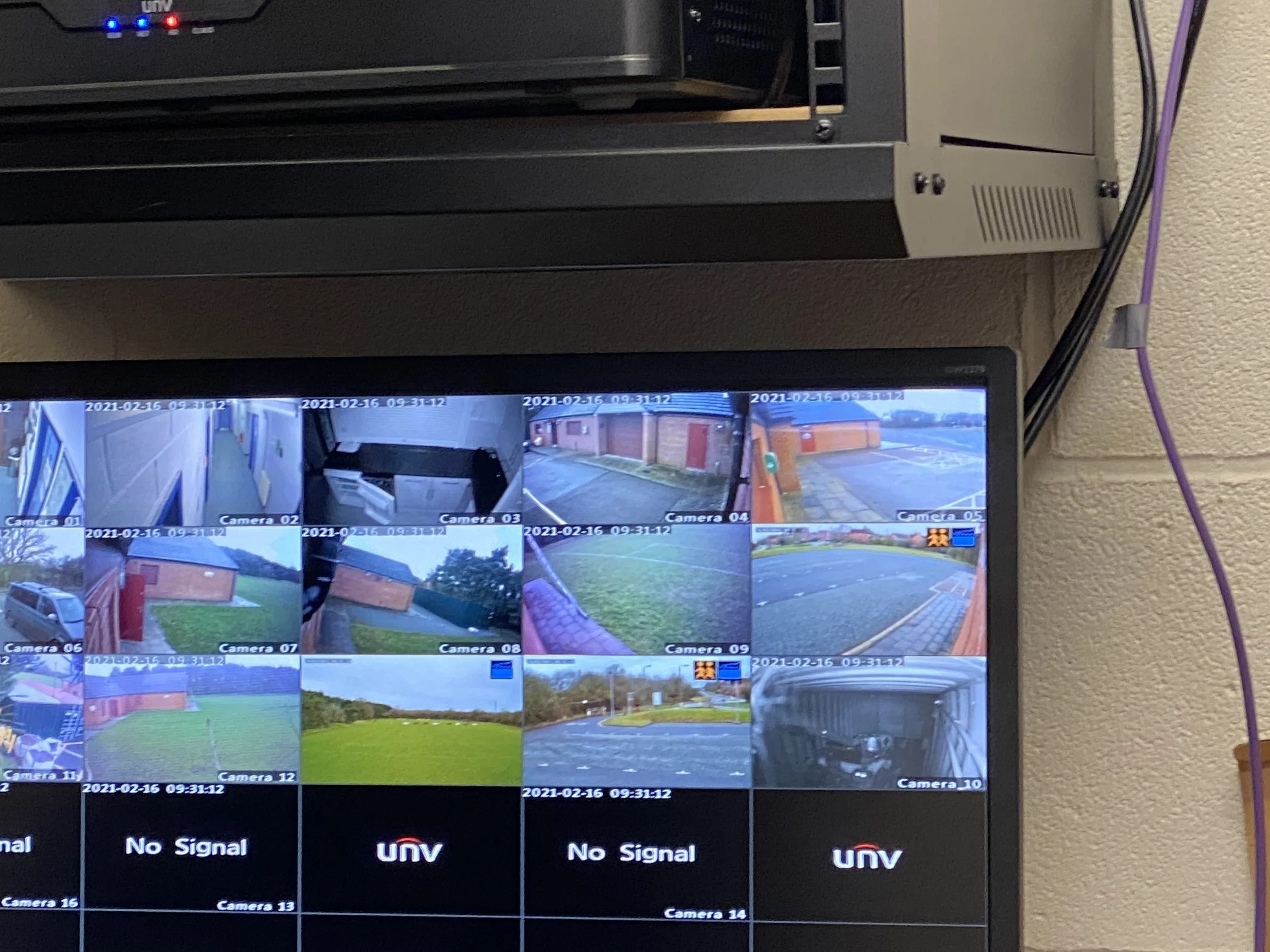 A television monitor displaying multiple camera feeds of different outdoor locations, with some cameras showing safe areas and others showing no signal.