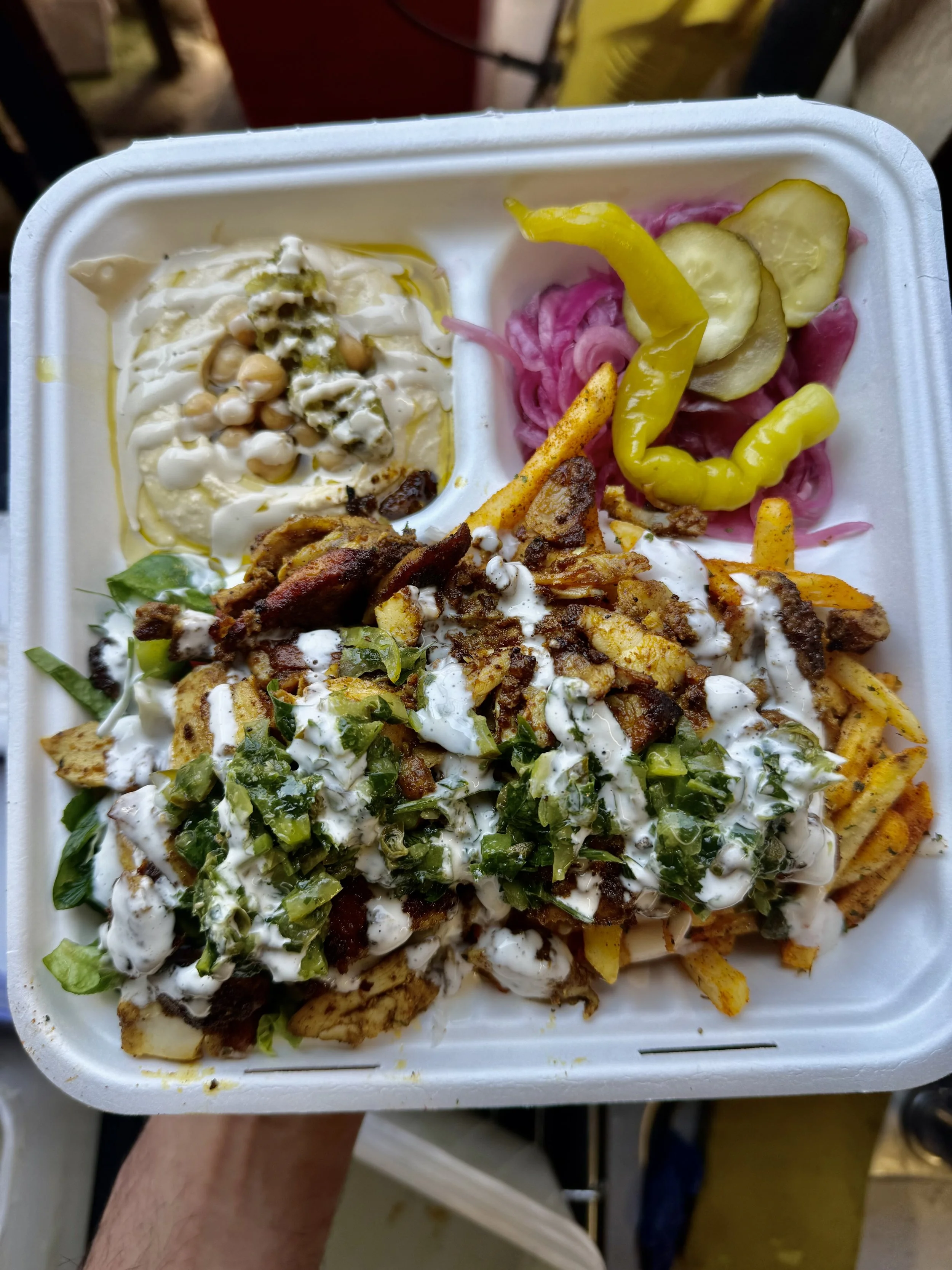 PITA deluxe box with chicken shawarma, hummus, salads, chips, pickles and sauces.