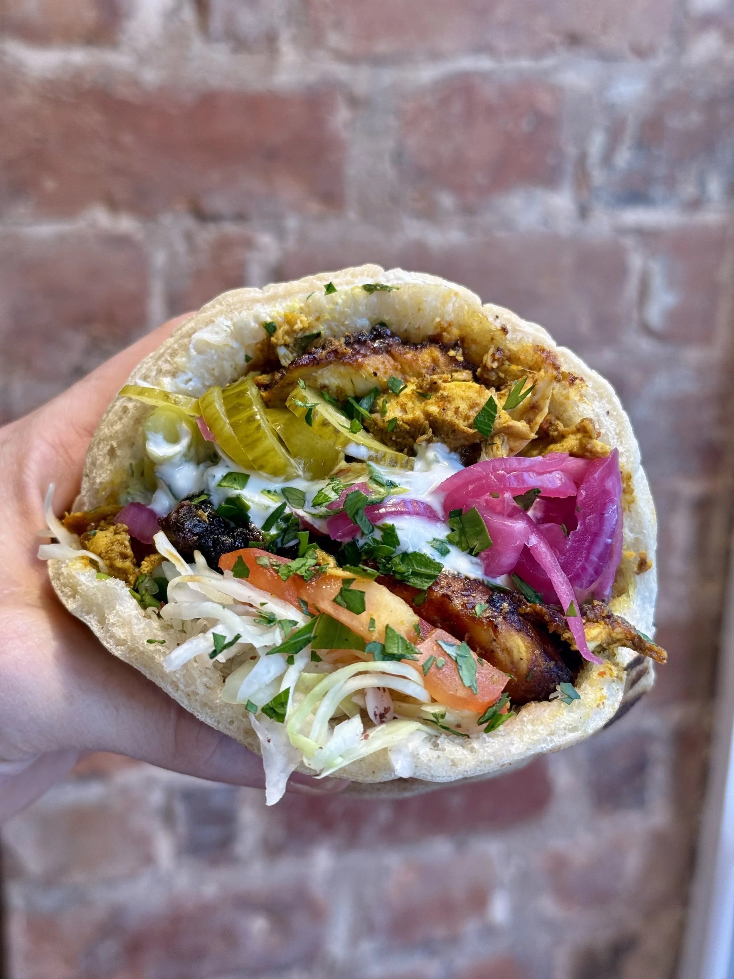 Chicken shawarma pita with salad, house pickles and sauce at PITA Shrewsbury