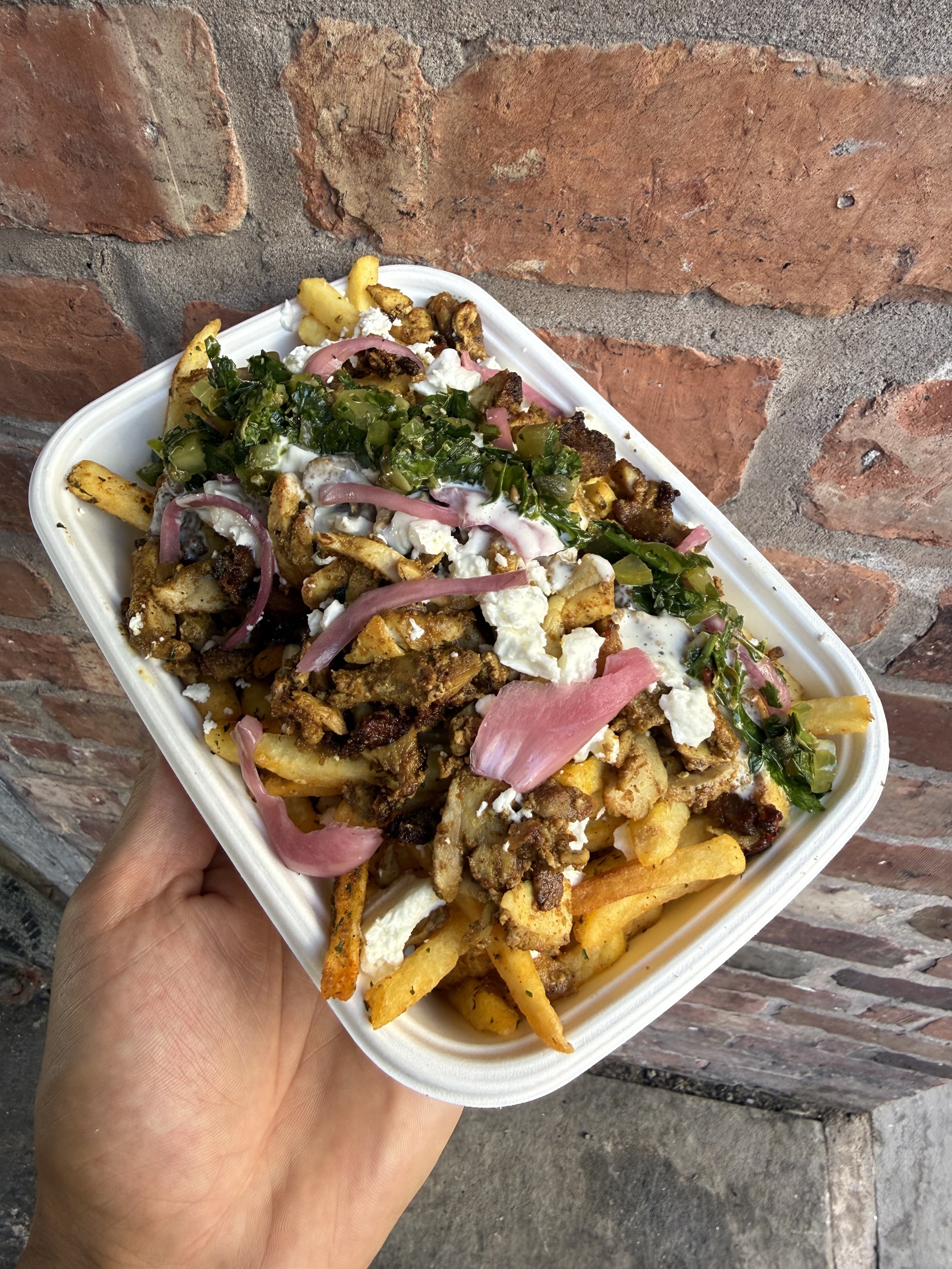 Loaded fries with meat, feta, house pickles and homemade sauces at PITA Shrewsbury.