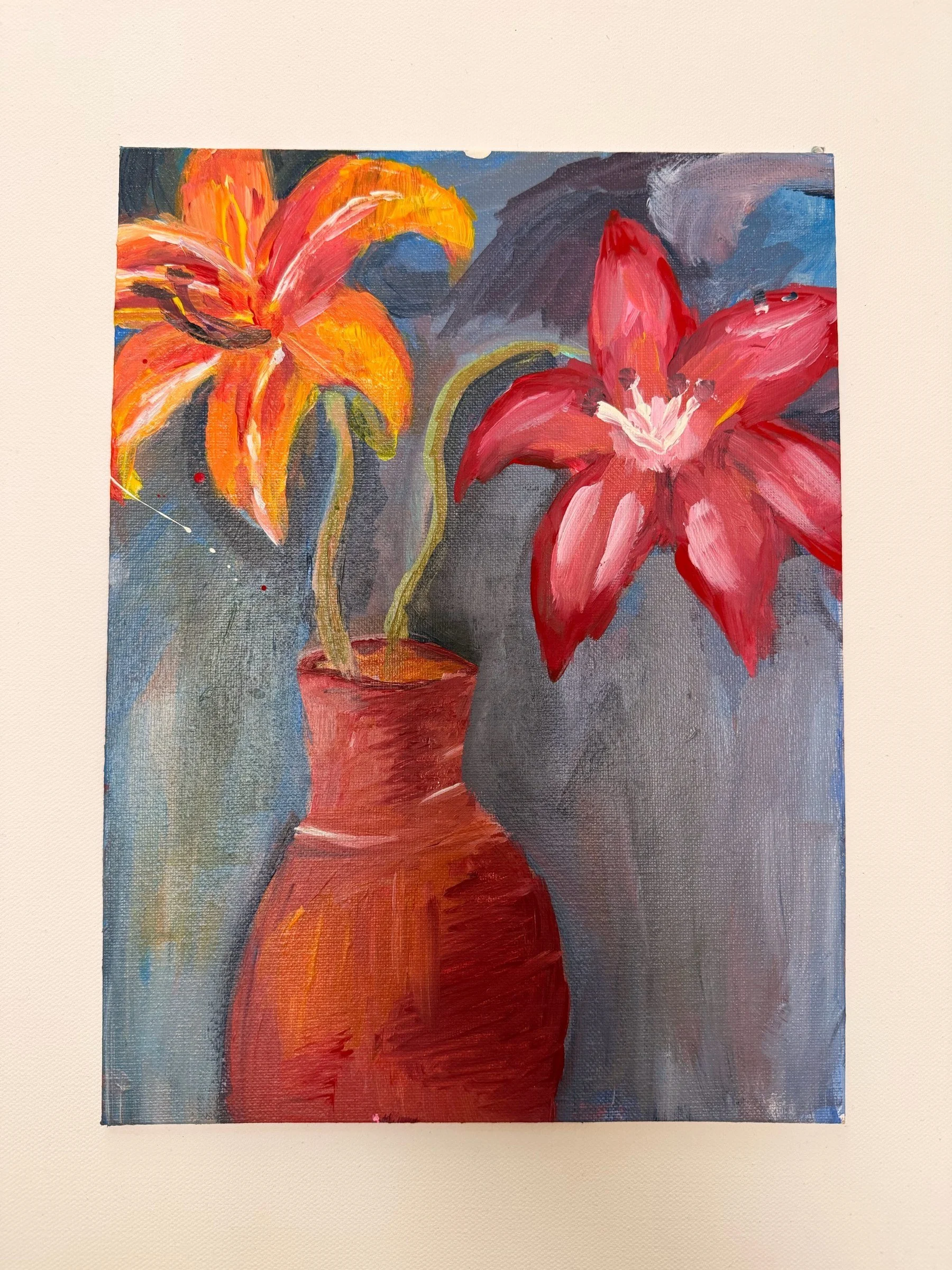 WATER LILIES. Acrylic on canvas. 9×12". Two lilies, one orange and one crimson, rise from a terracotta vase against loosely brushed grey and blue drapery. The warm vase and petals are set against cool background strokes to push the flowers forward.