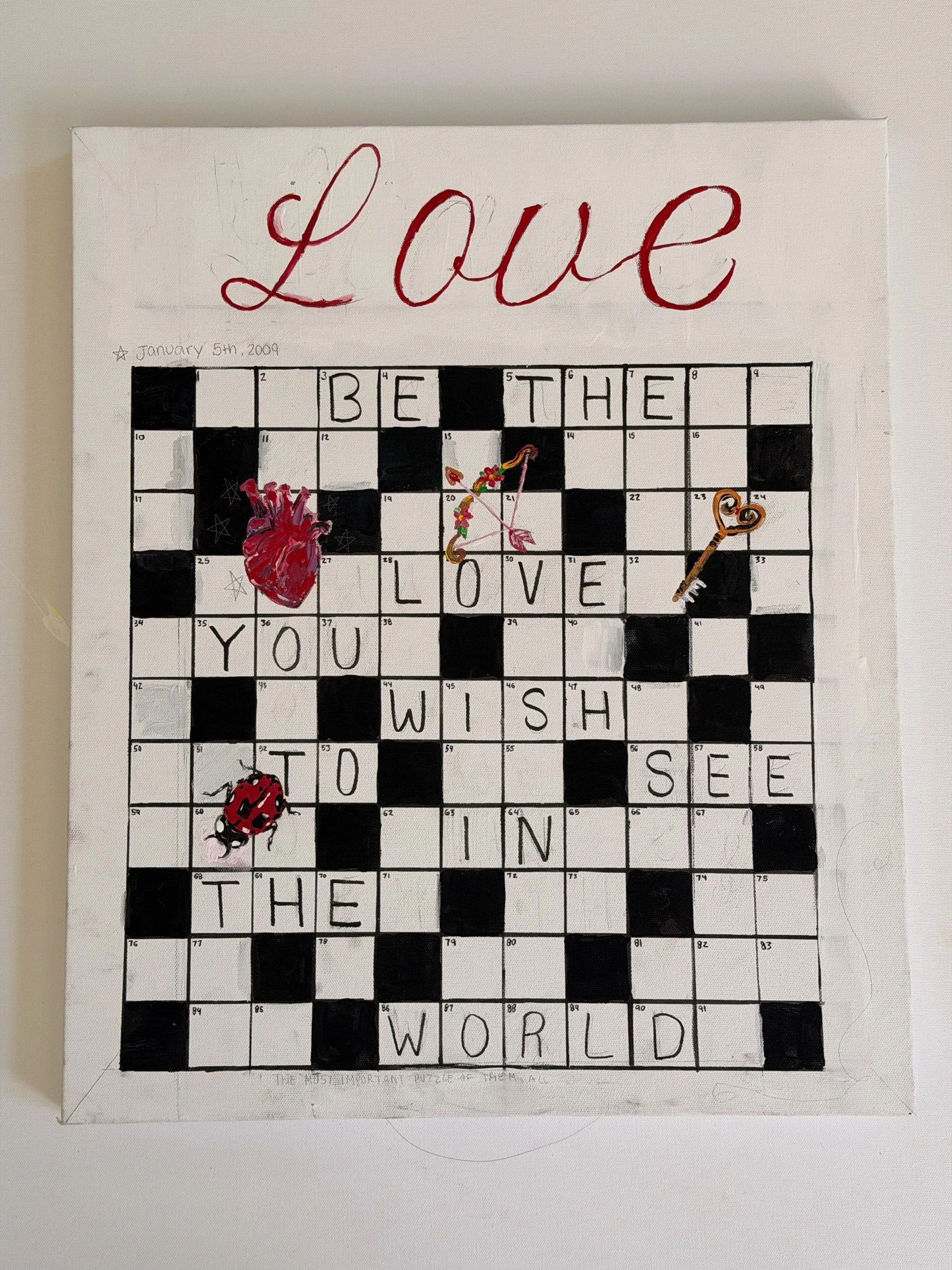 LOVE (CROSSWORD). Mixed media on canvas. A crossword grid painted on white canvas spells out BE THE LOVE YOU WISH TO SEE IN THE WORLD, with the word Love lettered in red script above it. Three-dimensional objects — an anatomical heart, a bow and arro