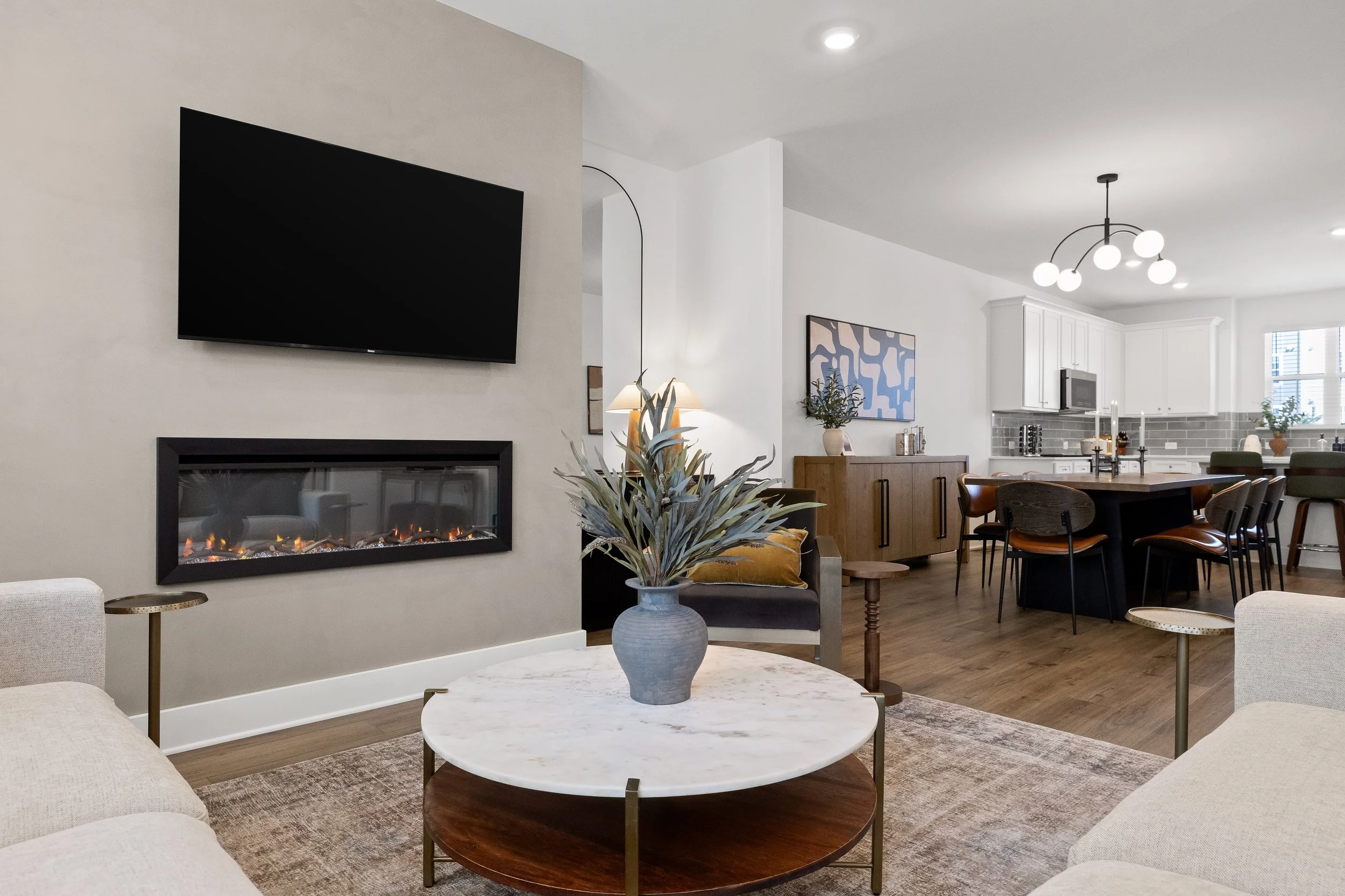 Bright, thoughtfully designed living space with fireplace, open dining area and fully equipped kitchen.