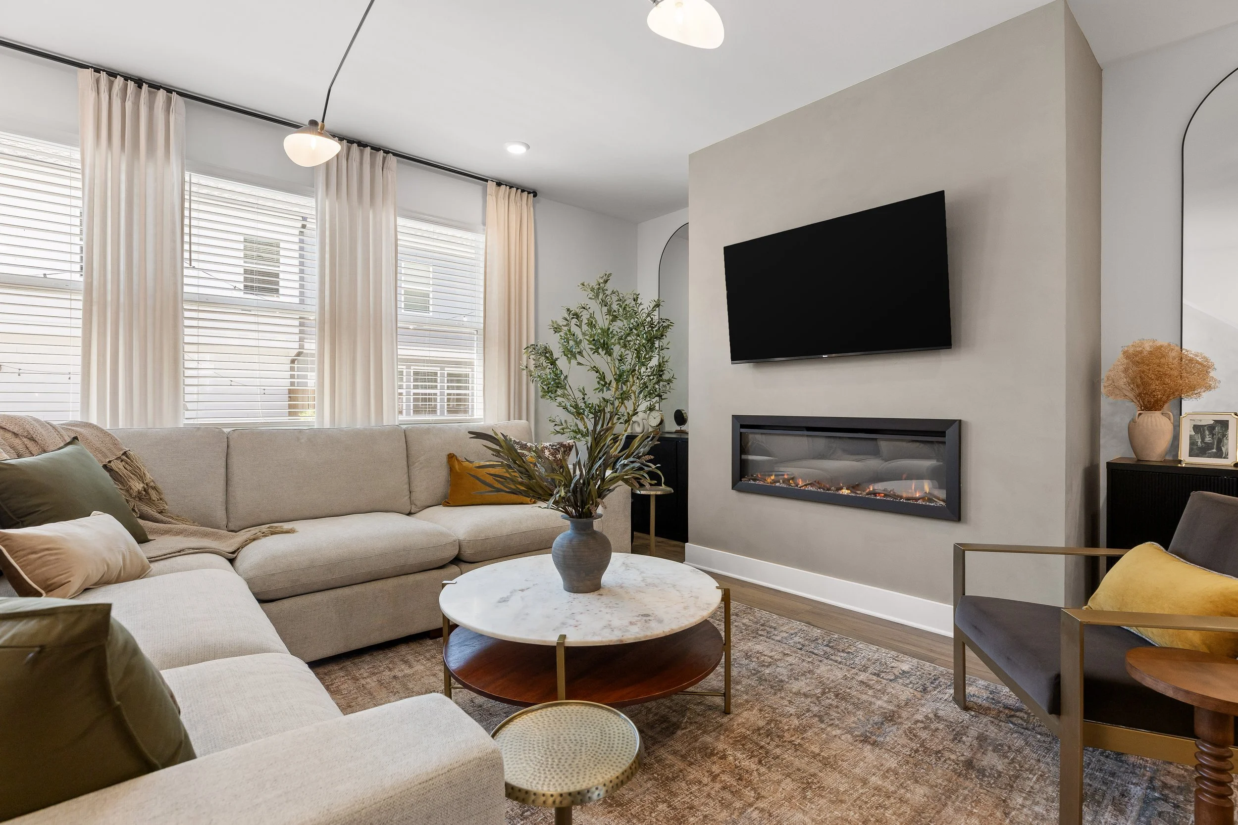 Living room at Summit & Stone Chattanooga vacation rental with fireplace and modern furnishings.