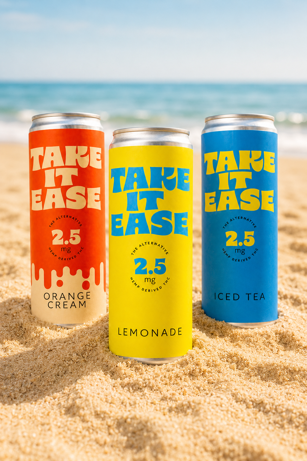 Three cans of Take It Easy hemp-derived THC beverages, with flavors orange cream, lemonade, and iced tea, placed on sandy beach near the ocean.